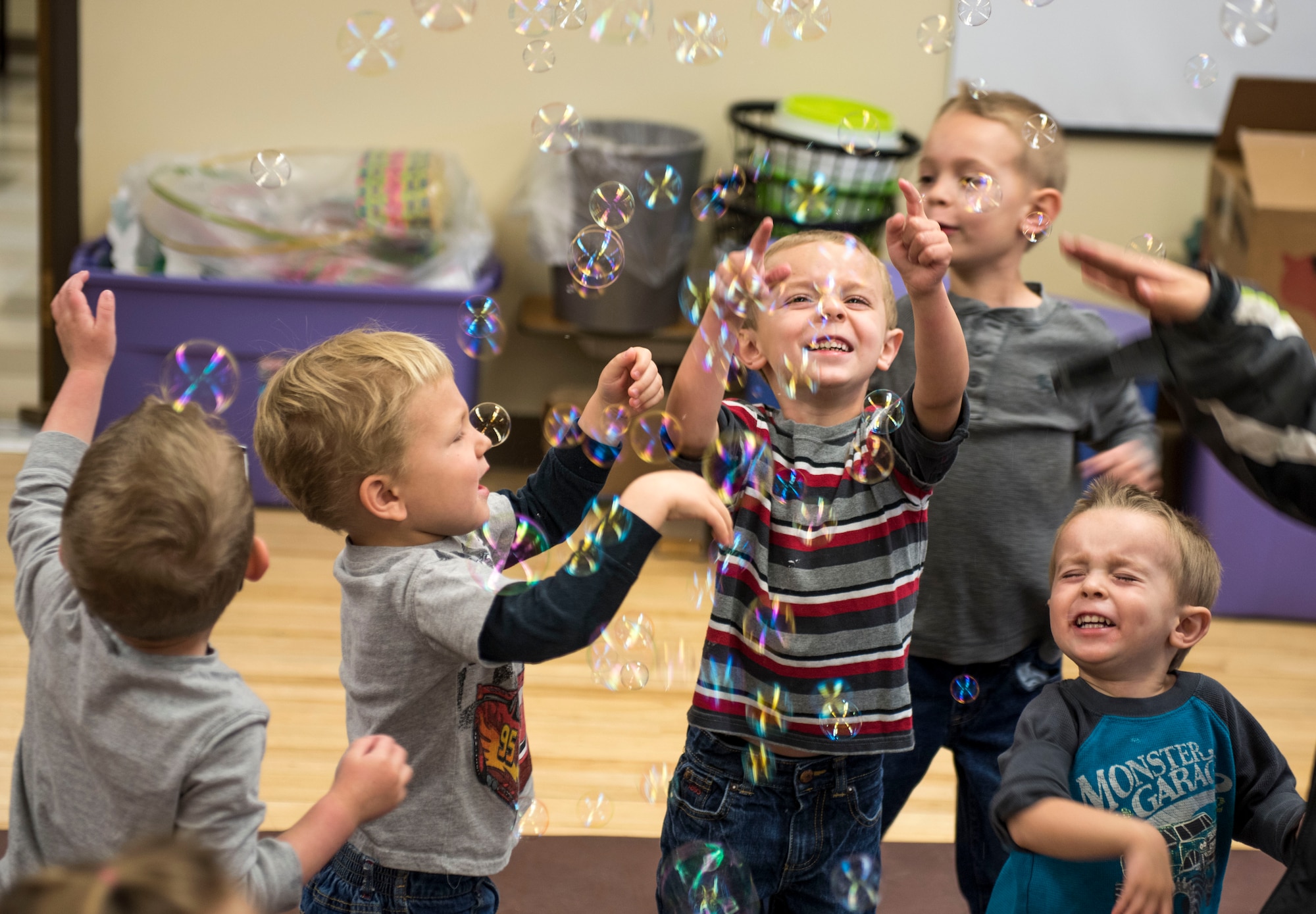 Children play with bubbles during the Sensory Camp at Mountain Home Air Force Base, Idaho, March 25, 2015. The Exceptional Family Member Program hosted the camp at the Youth Center to give children the opportunity to interact with one another and experience a variety of sensations of objects and textures. (U.S. Air Force photo by Airman 1st Class Jeremy L. Mosier/Released)