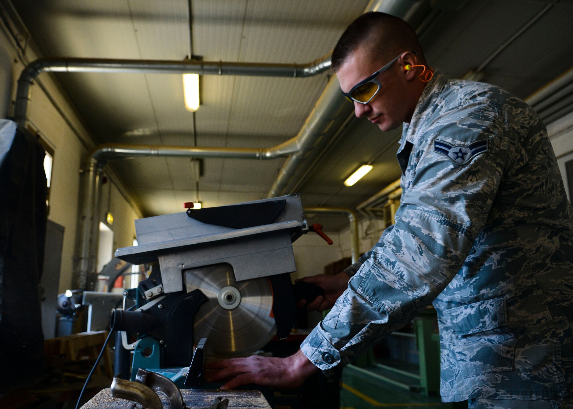 U.S. Air Force Airman 1st Class Adam Cook, 31st Civil Engineer Squadron structural journeyman, cuts wood April 7, 2015, at Aviano Air Base, Italy. Carpentry is one of the core skills of a structures Airman. (U.S. Air Force photo by Senior Airman Austin Harvill/Released)