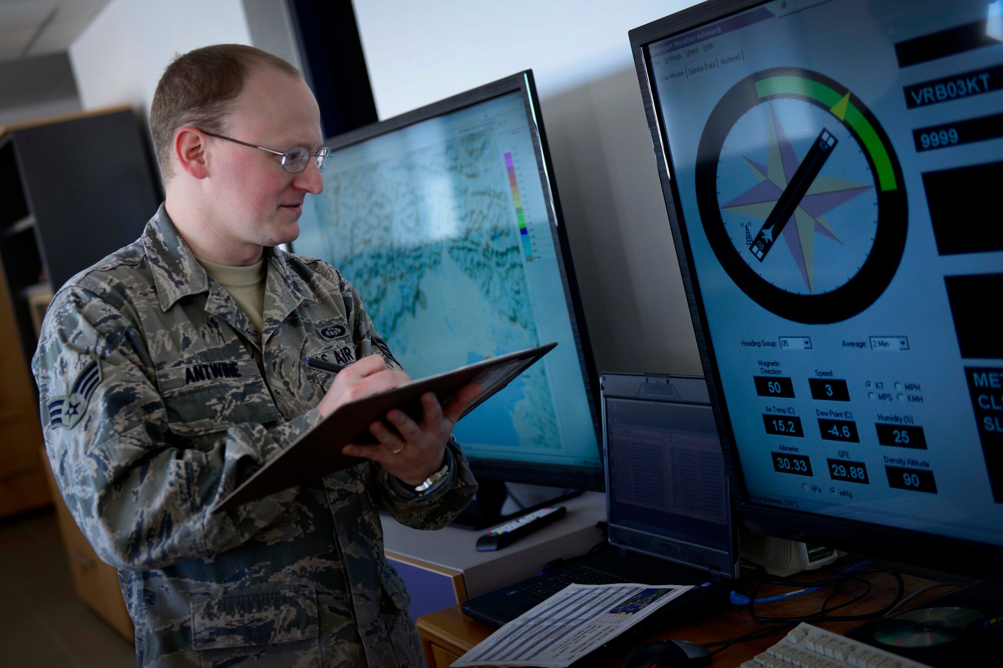 U.S. Air Force Senior Airman Aaron Antwine, 31st Operations Support Squadron weather forecaster, observes and records weather conditions, April 8, 2015 at Aviano Air Base, Italy. Weather personnel prepare forecasts, issue weather warnings and brief pilots to ensure flight safety and awareness. (U.S. Air Force photo by Senior Airman Areca T. Wilson/Released)