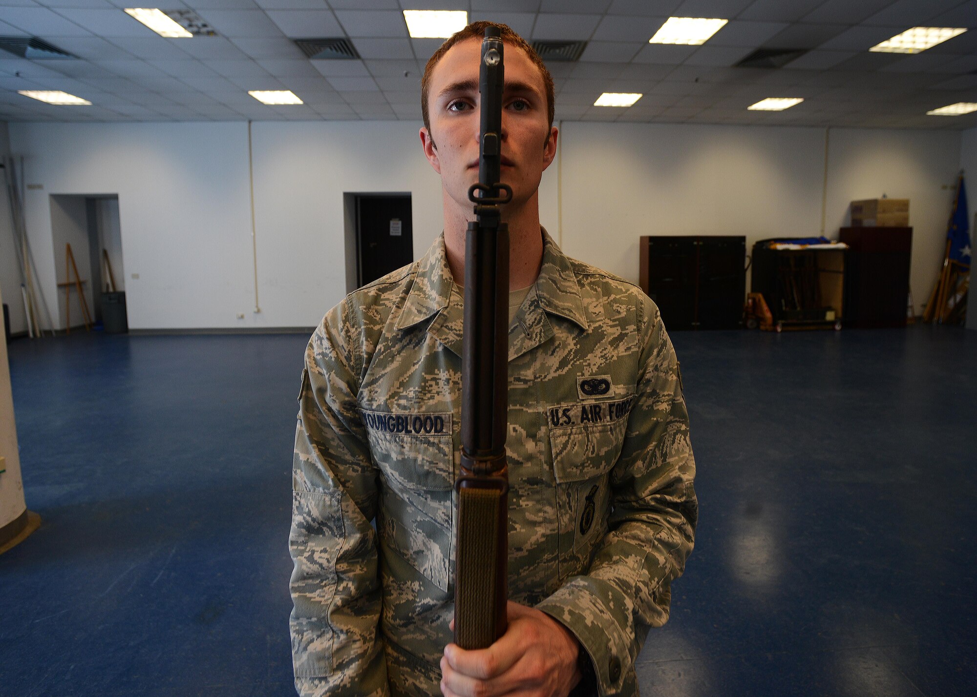 U.S. Air Force Senior Airman Justin Youngblood, 31st Fighter Wing honor guardsman, presents arms during practice, April 8, 2015, at Aviano Air Base, Italy. To obtain the title of honor guardsman, each member is tested on marching, rifle and flag movements and flawlessly reciting the honor guard charge. (U.S. Air Force photo by Airman 1st Class Deana Heitzman/Released)  