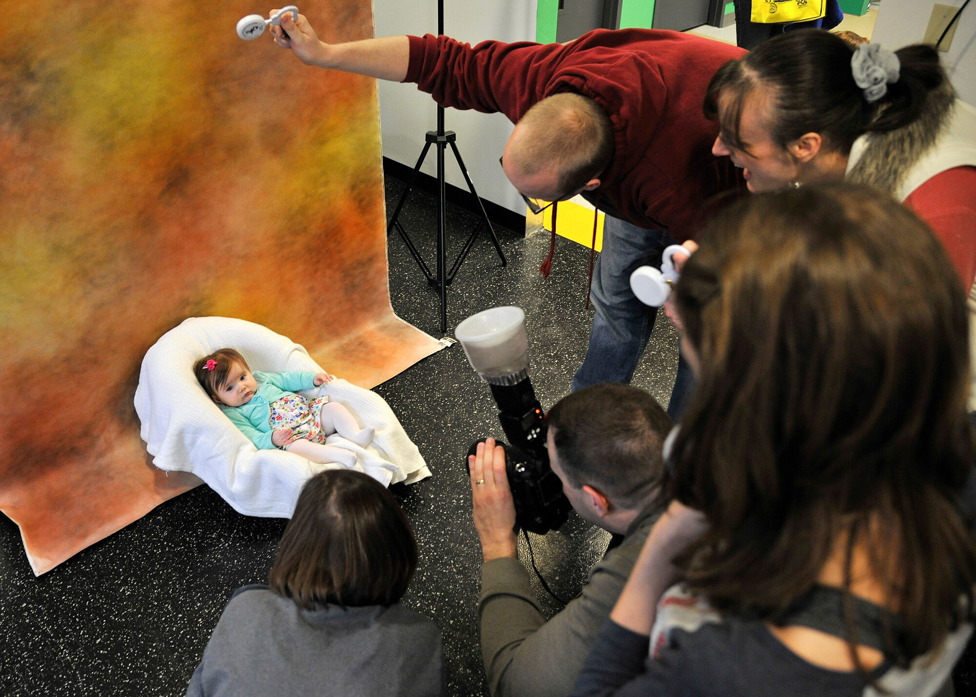 Abigail Hitzelberger, 5 months old, poses for her parents and photographer during the Beautiful Child Photo Shoot and Activity Fair on April 7, 2015, at Liberty Square on Grand Forks Air Force Base, N.D. The goal of the event was to give families a chance to get together to celebrate Month of Military Child as well as Child Abuse Prevention Month, which are observed in April. (U.S. Air Force photo by Senior Airman Xavier Navarro/released)