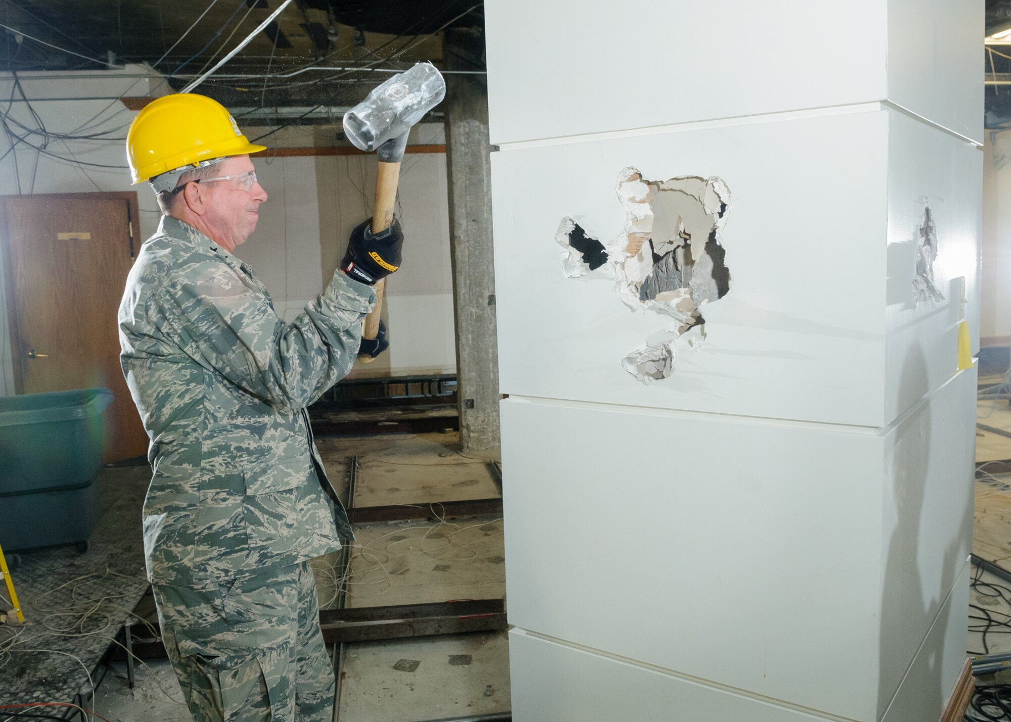 Maj. Gen. John Shanahan, 25th Air Force commander, lends a hand Aug. 1, 2014, during the construction phase of the NAF's operation center. (U. S. Air Force photo by William Belcher)  