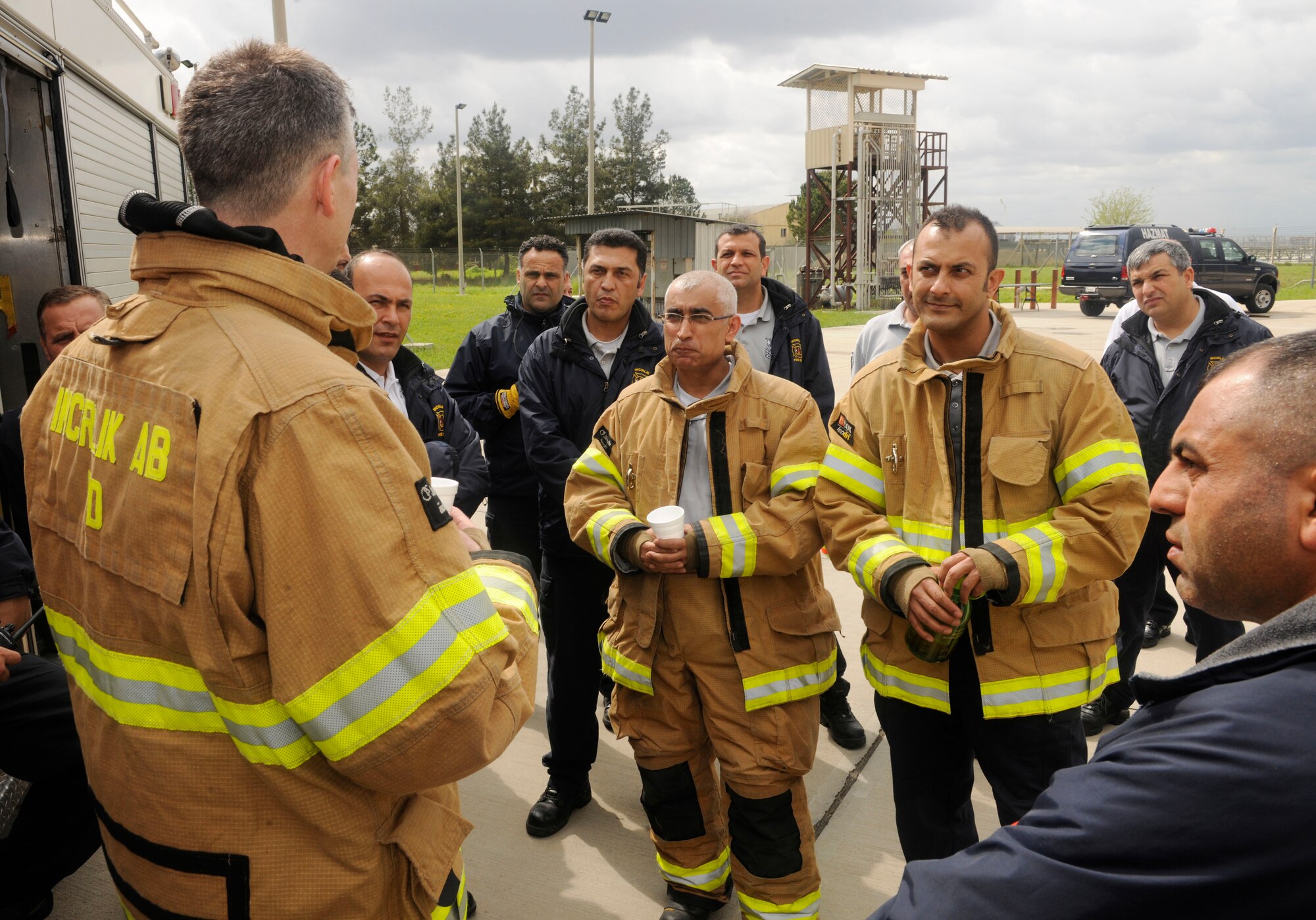 Firefighters from the 39th Civil Engineer Squadron Incirlik Fire Emergency Services speak with Col. Craig Wills, 39th Air Base Wing commander, after participating in a training exercise April 2, 2015, at Incirlik Air Base, Turkey. Wills embedded with the firefighters training as part of the Out Connecting with Airmen program. (U.S. Air Force photo by Senior Airman Krystal Ardrey/Released)