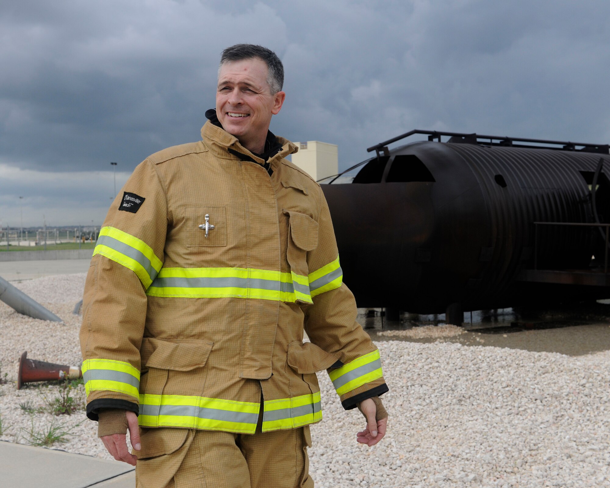Col. Craig Wills, 39th Air Base Wing commander, walks past a training aircraft April 2, 2015, at Incirlik Air Base, Turkey. Wills joined 39th Civil Engineer Squadron Incirlik Fire Emergency Services firefighters in a routine training exercise to gain a better understanding of their jobs. (U.S. Air Force photo by Senior Airman Krystal Ardrey/Released)
