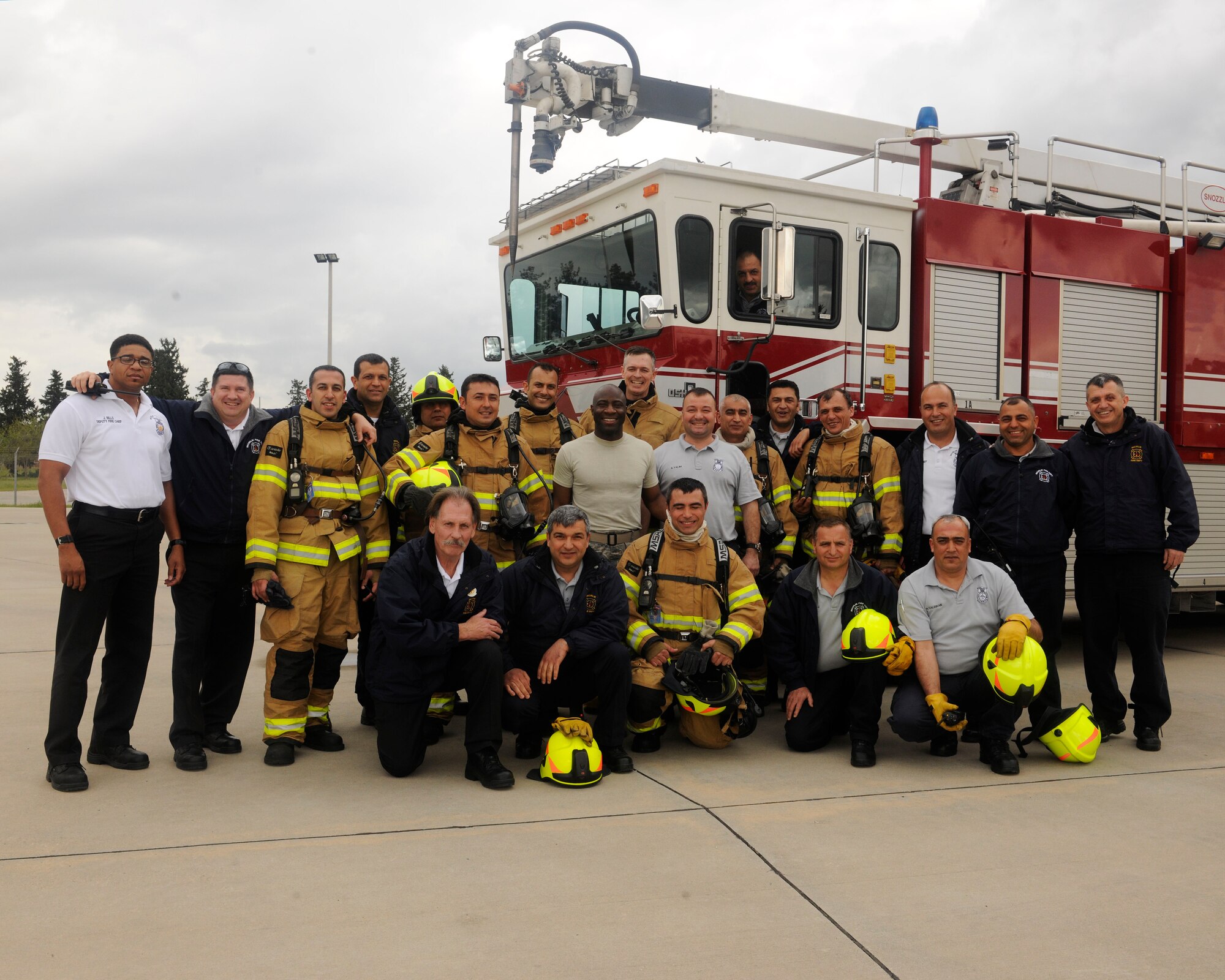 Col. Craig Wills, 39th Air Base Wing commander, Chief Master Sgt. Vegas Clark, 39th ABW command chief and firefighters from the 39th Civil Engineer Squadron Incirlik Fire Emergency Services pose for a group photo April 2, 2015, at Incirlik Air Base, Turkey. Wills and Clark participated in a training with the firefighters to gain a better understanding of their jobs during the Out Connecting with Airmen program. (U.S. Air Force photo by Senior Airman Krystal Ardrey/Released)