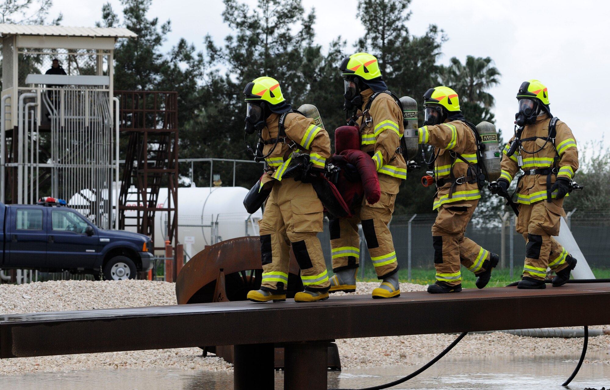 Firefighters from the 39th Civil Engineer Squadron Incirlik Fire Emergency Services and leadership from the 39th Air Base Wing practice extinguishing fires inside a simulated aircraft April 2, 2015, at Incirlik Air Base, Turkey. The event was part of the Out Connecting with Airmen program, which allows the base commander and command chief experience a different job around base each week. (U.S. Air Force photo by Senior Airman Krystal Ardrey/Released)