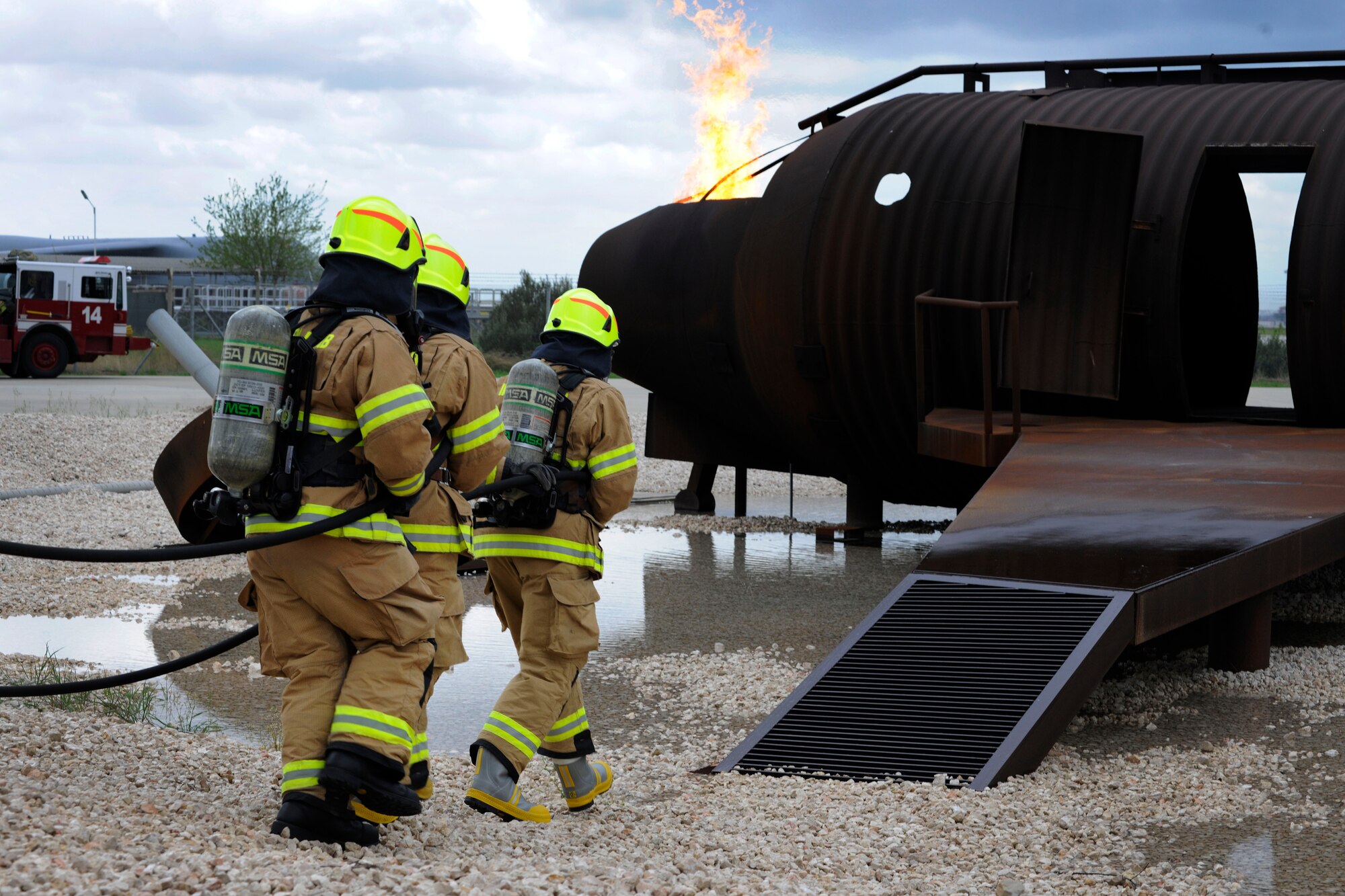 Col. Craig Wills, 39th Air Base Wing commander, Chief Master Sgt. Vegas Clark, 39th ABW command chief, and a firefighter from the 39th Civil Engineer Squadron Incirlik Fire Emergency Services approach a training aircraft to practice extinguishing a fire on the flight deck April 2, 2015, at Incirlik Air Base, Turkey. Wills and Clark spent an afternoon learning about firefighter equipment, firefighting and rescue techniques and ended the day by participating in a practical exercise. (U.S. Air Force photo by Senior Airman Krystal Ardrey/Released)