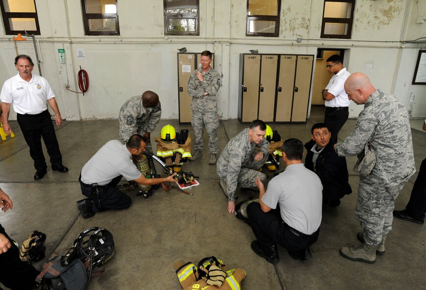 Firefighters from the 39th Civil Engineer Squadron Incirlik Fire Emergency Services explain the function of each piece of equipment firefighters wear to Col. Craig Wills, 39th Air Base Wing commander, and Chief Master Sgt. Vegas Clark, 39th ABW command chief April 2, 2015, at Incirlik Air Base, Turkey. Wills and Clark embedded into the firefighter’s training as part of the commander’s Out Connecting with Airmen program. (U.S. Air Force photo by Senior Airman Krystal Ardrey/Released)