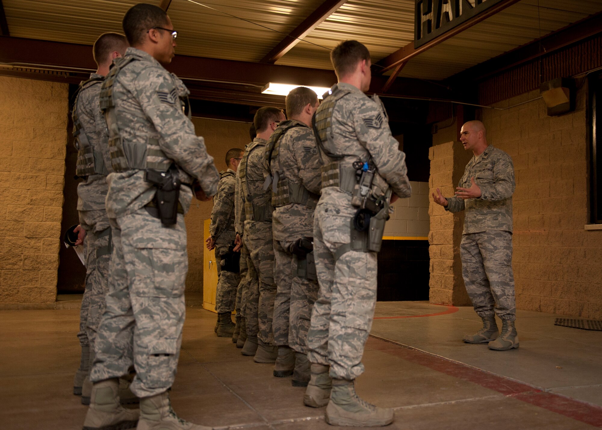 (HOLLOMAN AIR FORCE BASE, N.M.) Chaplin (Capt.) Arkadiusz Szyda, Unit Chaplin to the 49th Security Forces Squadron, speaks to security forces members during a late night shift change at Holloman Air Force Base, N.M April 8, 2015. Being in the military for only two years, Szyda explains that the changes in his life are still on-going. Szyda expressed that hearing stories about the invasion of Normandy from World War II veterans and watching documentaries initially motivated him to join the military. Being able to impact an Airman’s resiliency is the driving force behind his motivation to stay in. After hearing stories of a Chaplin jumping from foxhole to foxhole during WWII encouraging and inspiring the young soldiers during a time of great stress, will always touch his heart and continue to drive him in helping others.  Szyda stated that it is not his expectation to see results or the impact he has on Airmen, but to know that the family, friends, spouses, and co-workers see that impact or result shows how being a Chaplin contributes to the military mission. (U.S. Air Force photo by Staff Sgt. E’Lysia A. Wray/Released)