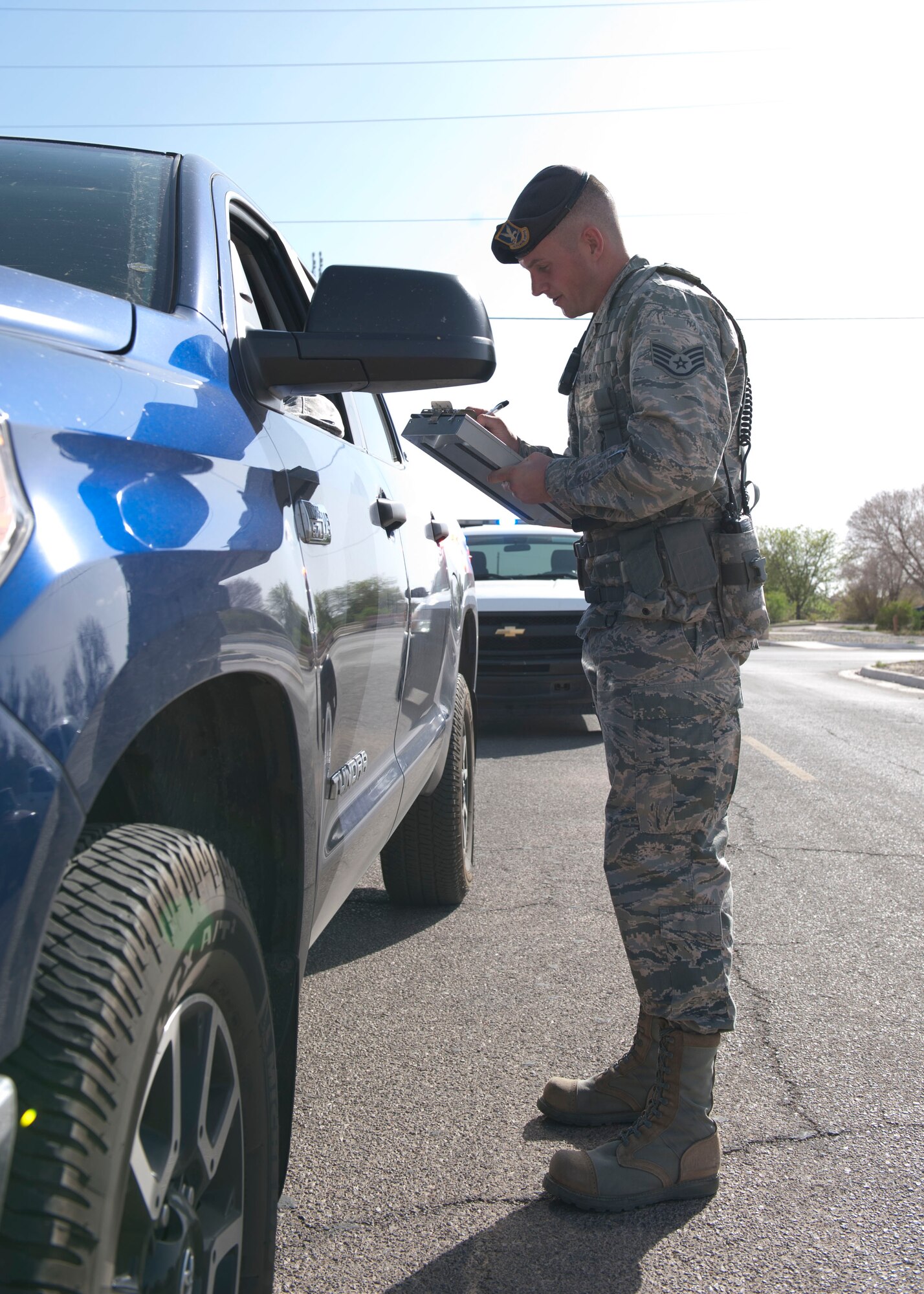 (HOLLOMAN AIR FORCE BASE, N.M.) Staff Sgt. Patrick Wilson, 49th Security Forces Squadron flight sergeant, writes a citation for a routine traffic stop at Holloman Air Force Base, N.M. April 8, 2015. “Being a part of something bigger than myself gave me purpose, that is why I choose to join the military,” said Wilson. Showing the retirees that the ‘new age’ military can keep up and continue to support the mission is what gives Wilson his motivation to continue to serve. Wilson’s uncle, who was a Colonel in the Air Force as a B-52 Stratofortress pilot and last served as a Vice Commander at Barksdale Air Force Base, La., was his major influence to join the Air Force. “We protect and enforce guidelines to ensure the safety of the people on this installation. In my opinion that is how we contribute to the military mission,” said Wilson. Wilson joined April 26, 2005 and originally wanted to be a military working dog handler, but he is happy with his job and looks forward to the many opportunities to come. (U.S. Air Force photo by Staff Sgt. E’Lysia A. Wray/Released)