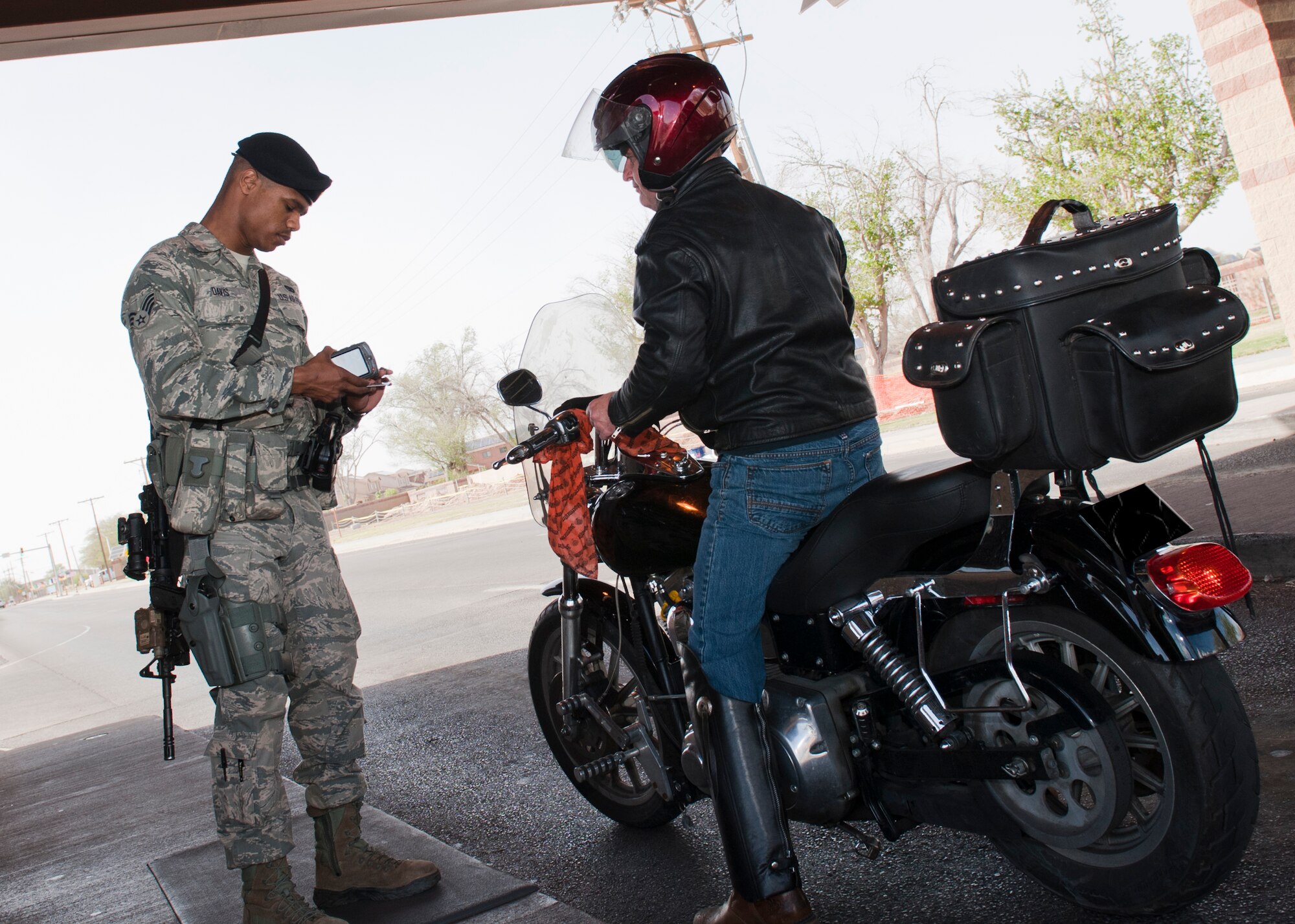 (HOLLOMAN AIR FORCE BASE, N.M.) Senior Airman Amaan Davis, 49th Security Forces Squadron patrolman, checks a retiree’s identification card at Holloman Air Force Base, N.M. April 8, 2015. Since choosing to serve in the military Davis has gained a sense of satisfaction from knowing that he is the first line of defense for any installation he is stationed at. Davis gains his motivation to continue to serve from the retirees that come through the gate and thank him for his service. Davis grandfather influenced him to join the Air Force and asked him to do a minimum of four years. Davis feels that being a first responder to any incident on an installation helps contribute to the overall mission of protecting this nation. “My grandfather, schooling opportunities, safe housing on base, and the chances for travel made me join,” said Davis. Davis has been in the military for three years, even though security forces was his last choice, he enjoys his job and looks forward to a long and fulfilling career in the Air Force. (U.S. Air Force photo by Staff Sgt. E’Lysia A. Wray/Released)