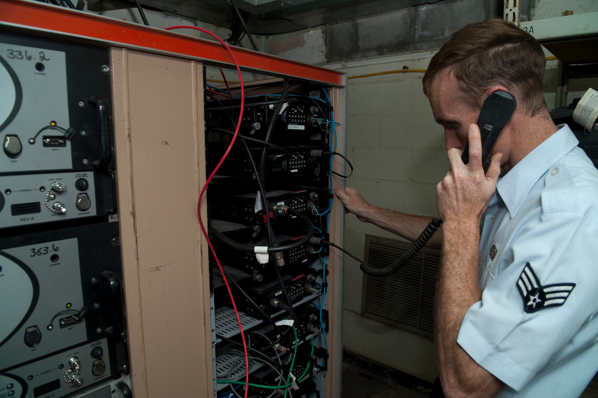 Senior Airman Anthony Payne, Ground Radio technician, runs checks on radio equipment to ensure seamless communication capability for Aircraft operating out of Holloman Air Force Base, N.M., April 8, 2015. Ground Radio communications is responsible for installing, maintaining and repairing fixed and transportable transmitters, receivers, transceivers and related equipment. “Serving has changed my life a lot,” said Payne. “I found something that I love to do, in a career field that I did not choose but I have fallen in love with it. It’s definitely given me a lot more direction in life.” (U.S. Air Force photo by Senior Airman Chase Cannon/Released)