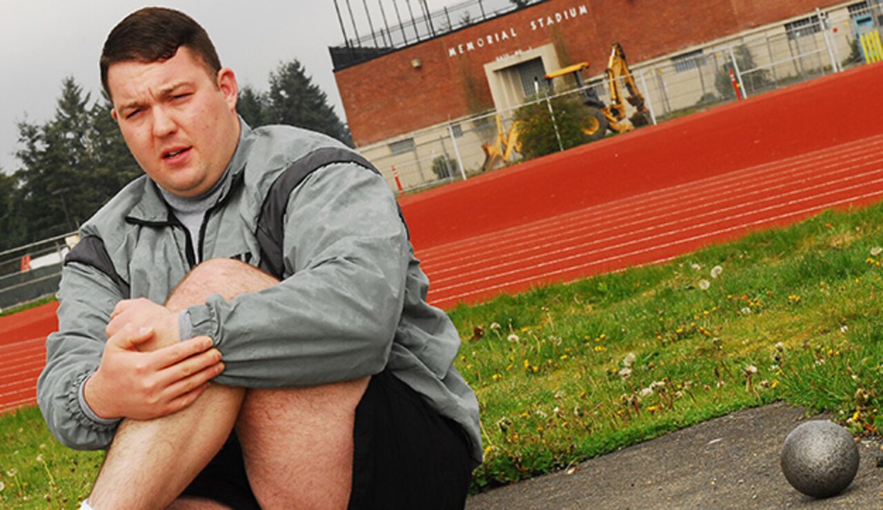 Then-Army Sgt. Joshua Andrew takes a break during track and field practice at Cowan Memorial Stadium on Joint Base Lewis-McChord, Wash., April 16, 2013. Andrew, then a member of JBLM’s Warrior Transition Battalion, won the gold medal during shot put competition at the 2015 Army Trials track and field competition at Fort Bliss, Texas, April 1, 2015. U.S. Army photo by Sgt. Zachary Gardner