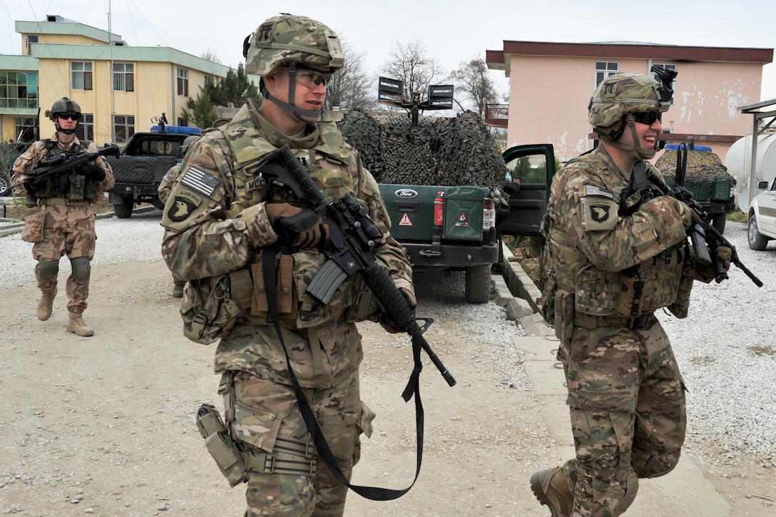 U.S. and Czech soldiers depart the Bagram district governor's building after a meeting and head back to their mine-resistant, ambush-protected vehicles in Bagram, Afghanistan, March 26, 2015. 