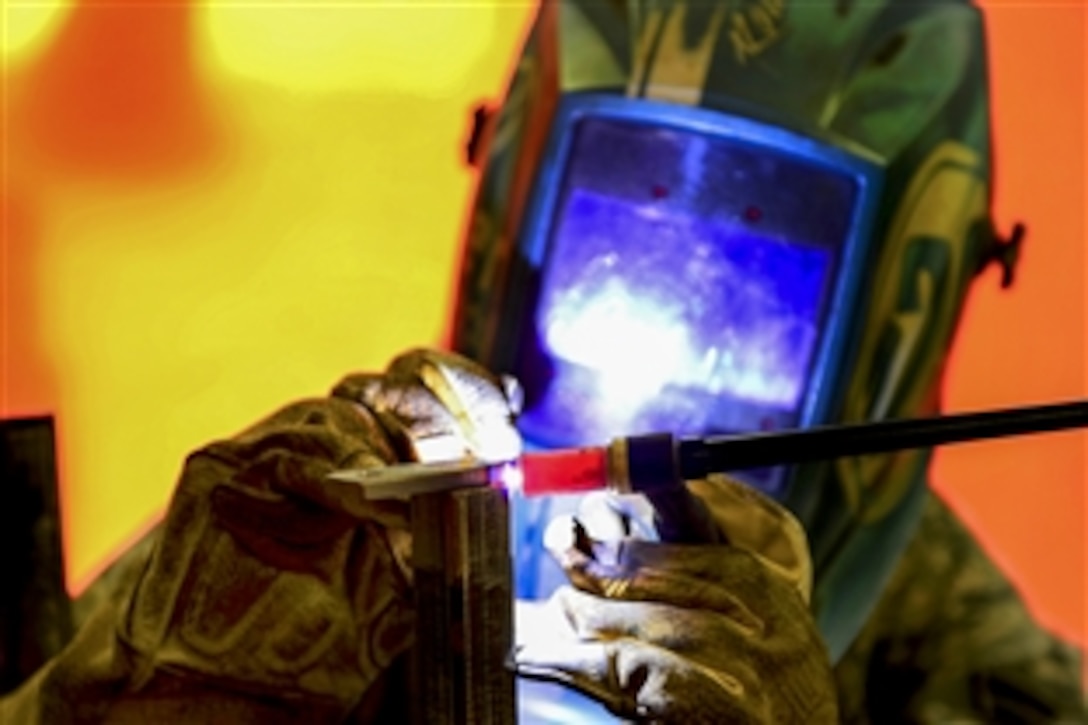 U.S. Air Force Airman 1st Class Jordan Barfield uses tungsten inert gas to weld a nitrogen cart booster stand on Aviano Air Base in Italy, April 8, 2015. Barfield is an aircraft metals technology journeyman assigned to the 31st Maintenance Squadron.