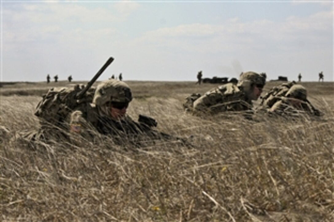 Left to right: U.S. Army Spc. Simon Saliba, 1st Lt. David A. Poole and Sgt. Timothy Dehaas obtain tactical security positions as fellow soldiers move toward their objective during a live-fire exercise in Romania, April 8, 2015. The purpose of the exercise is to demonstrate unit capabilities to Romanian military counterparts in support of Operation Atlantic Resolve South. The soldiers are assigned to 2nd Squadron, 2nd Cavalry Regiment.