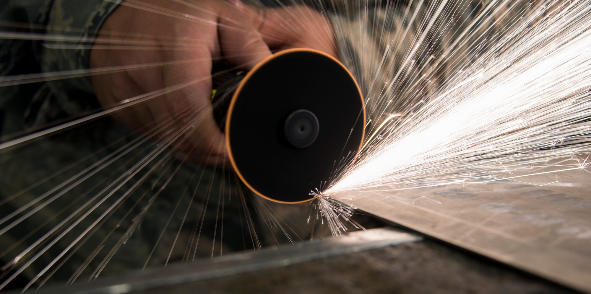 Senior Airman Kyle Lisenbee, 919th Special Operations Maintenance Squadron fabrication flight, sands down a piece of aluminum for an engine cover of a C-145 at Duke Field, Fla., April 19, 2015. A combination of a welding and machine shop, the metals technology section focuses on the repair and reproduction of aircraft parts. (U.S. Air Force photo/Tech. Sgt. Jasmin Taylor)
