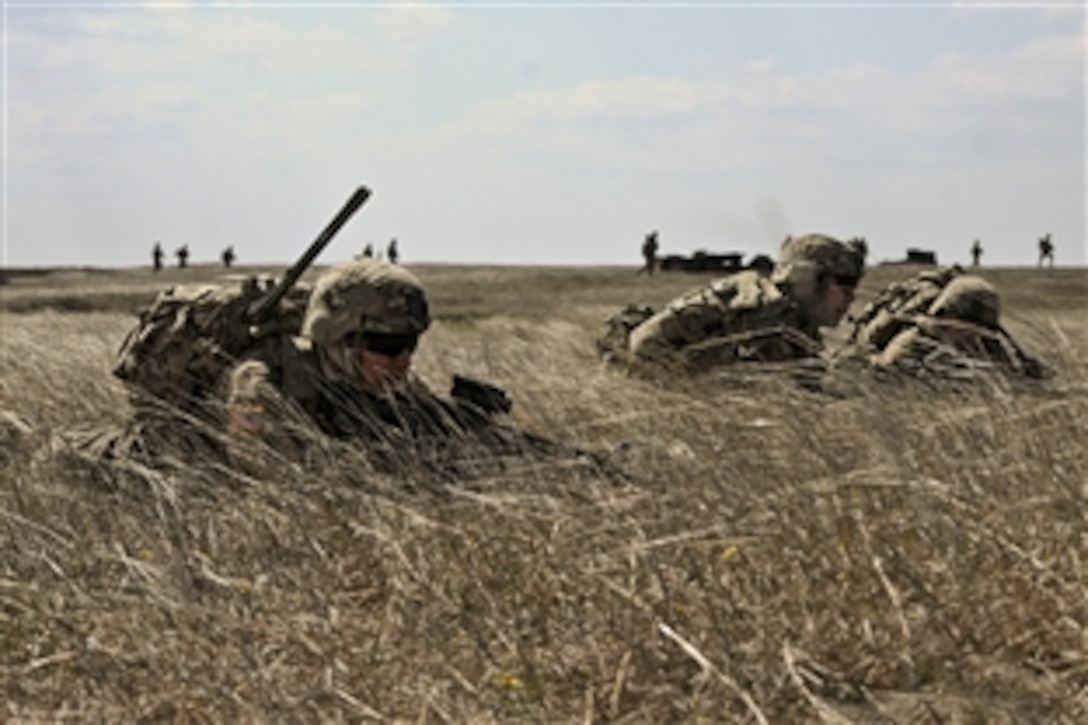Left to right: U.S. Army Spc. Simon Saliba, 1st Lt. David A. Poole and Sgt. Timothy Dehaas obtain tactical security positions as fellow soldiers move toward their objective during a live-fire exercise in Romania, April 8, 2015. The purpose of the exercise is to demonstrate unit capabilities to Romanian military counterparts in support of Operation Atlantic Resolve South. The soldiers are assigned to 2nd Squadron, 2nd Cavalry Regiment.