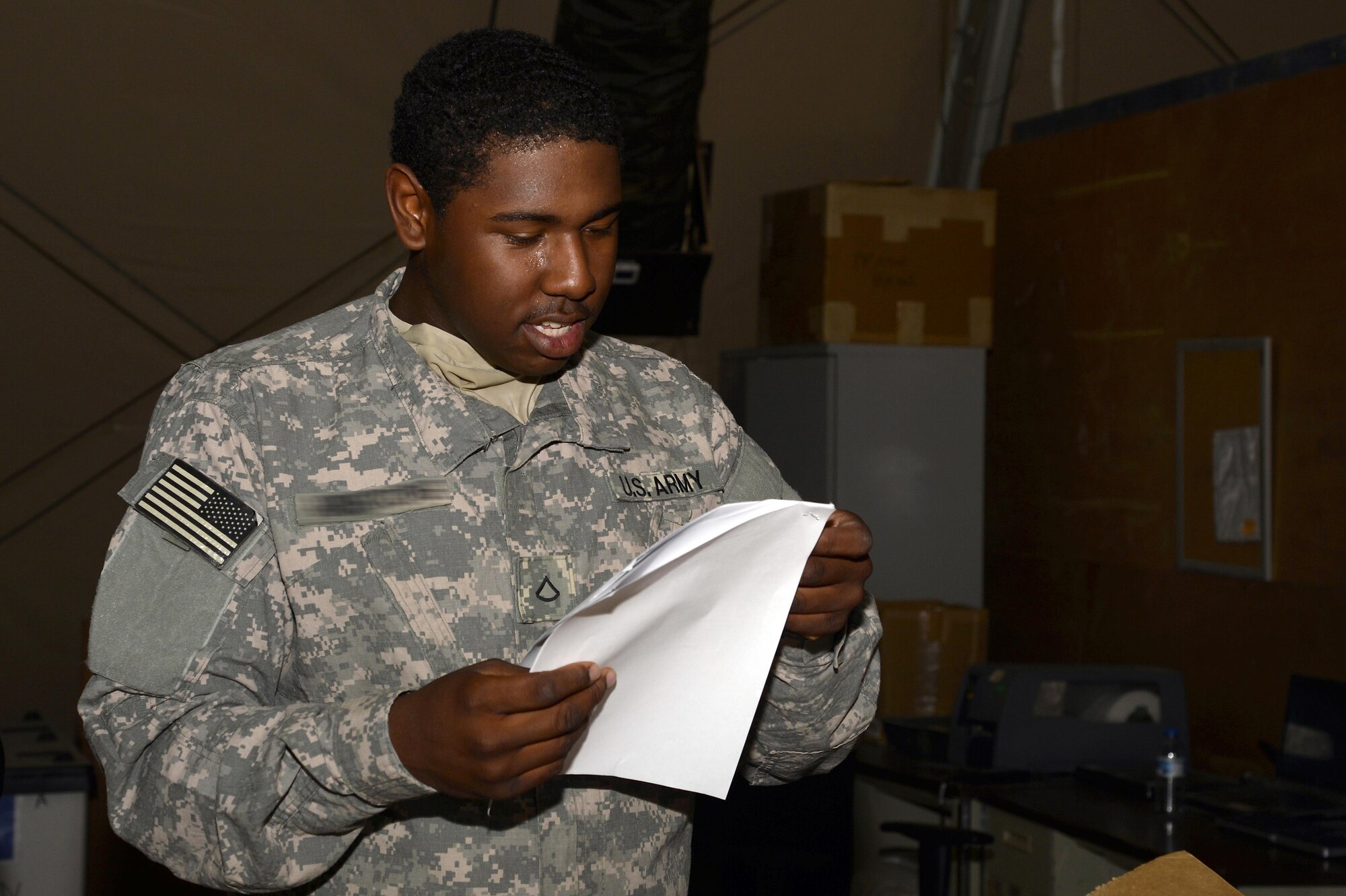 Private First Class Telly, turn-in and shipping section clerk, verifies and validates the required documentation for a recoverable/repairable part at an undisclosed location in Southwest Asia April 6, 2015. The procedure of verifying and validating the required documentation dispenses efficiency in the shipping procedure. Telly is currently deployed from Fort Bragg, N.C. (U.S. Air Force photo/Tech. Sgt. Marie Brown/RELEASED)