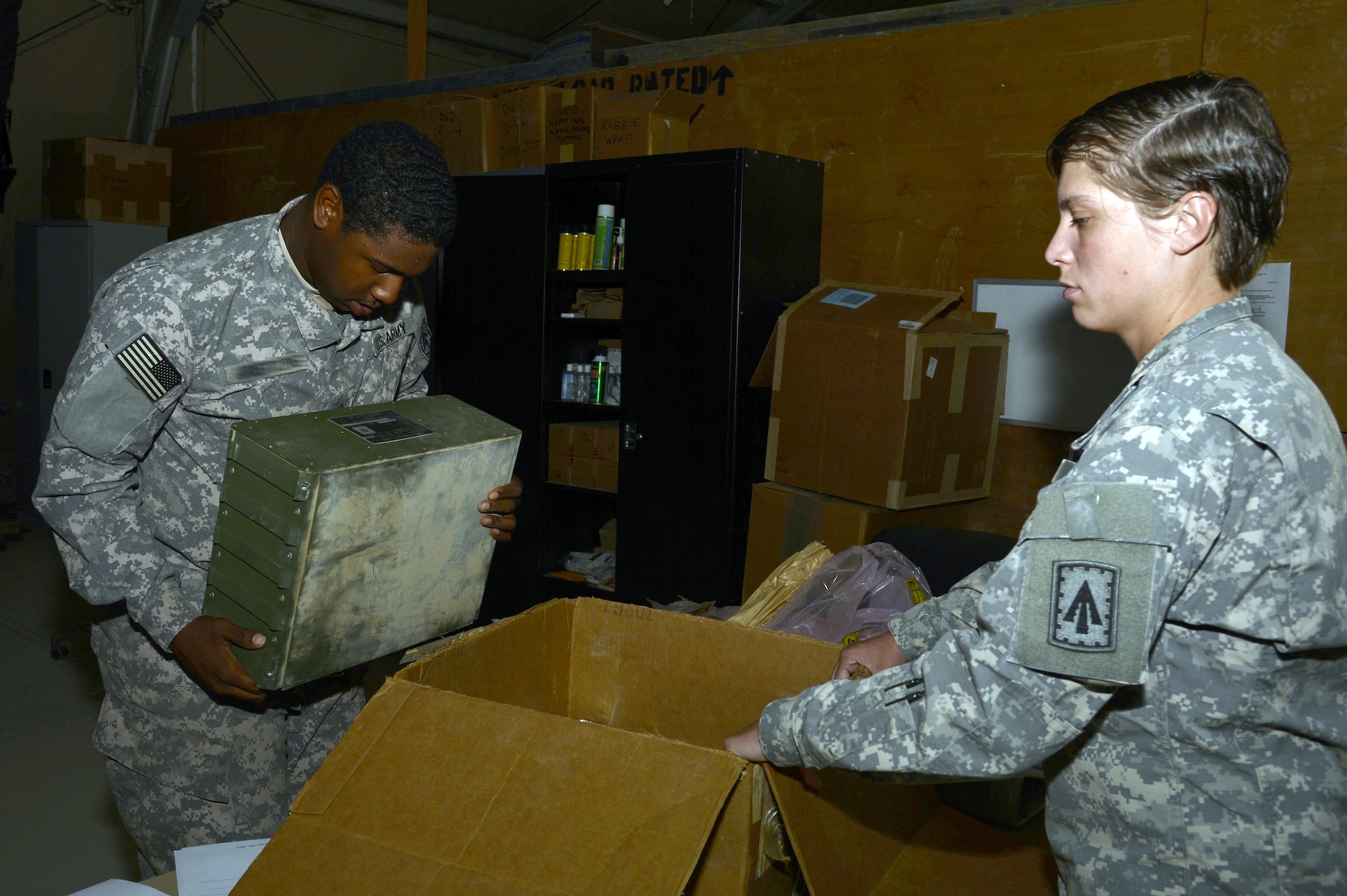 Private First Class Telly, turn-in and shipping section clerk, inspects a recoverable/repairable part during the turn-in process from an Air Defense customer at an undisclosed location in Southwest Asia April 6, 2015. Armstrong has contributed to expeditious processing of over 400 parts retrograded to the U.S. Army Depot. Telly is currently deployed from Fort Bragg, N.C. (U.S. Air Force photo/Tech. Sgt. Marie Brown/RELEASED)