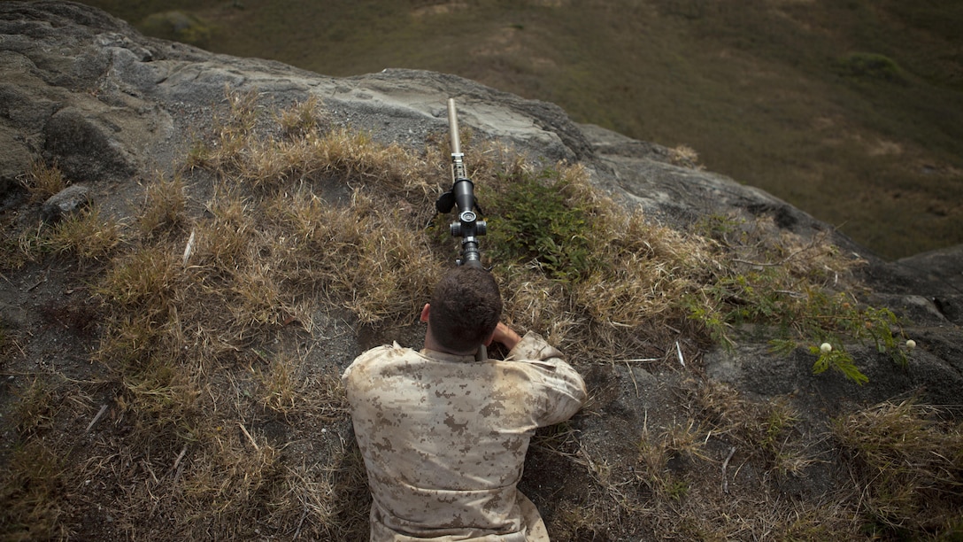 MLance Cpl. Patrick Casey, a Rifleman assigned to sniper platoon, 2nd Battalion, 3rd Marine Regiment, observes his target at Range 10 aboard Marine Corps Base Hawaii, April 8, 2015. Lance Cpl. Casey is improving his efficiency in sniper training prior to being sent to Scout Sniper Basic Course at Camp Pendleton, California. (U.S. Marine Corps photo by Lance Cpl. Julian Temblador, MCBH Combat Camera/Released)