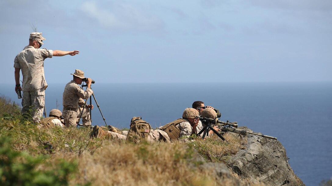 Marine scout snipers with Weapons Company, 2nd Battalion, 3rd Marine Regiment, conduct high angle shooting on top of Ulupau Crater at Range 10 aboard Marine Corps Base Hawaii, April 8, 2015. The training was different from their typical flat-level or slight elevation ranges. The high angle is considered anything 30 degrees or greater. (U.S. Marine Corps photo by Sgt. Sarah Dietz)
