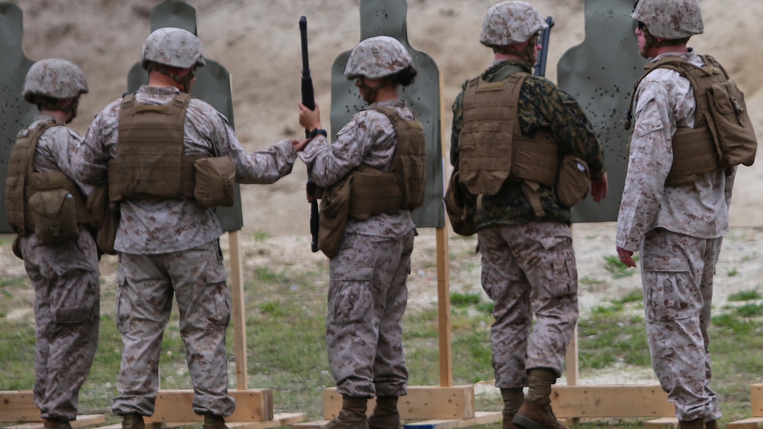 Marines with 2nd Intelligence Battalion review the impacts of their M1014 shotgun shots during a battalion field exercise aboard Marine Corps Base Camp Lejeune, North Carolina, April 7, 2015. The Marines used the M1014 shotgun to get a better understanding of the weapon, its handling and its capabilities.