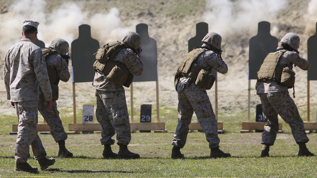 Marines with 2nd Intelligence Battalion fire M16A4 service rifles and M4 carbines at targets during a battalion field exercise aboard Marine Corps Base Camp Lejeune, North Carolina, April 6, 2015. Approximately 220 Marines with the unit qualified with the weapons during day and night combat marksmanship training.