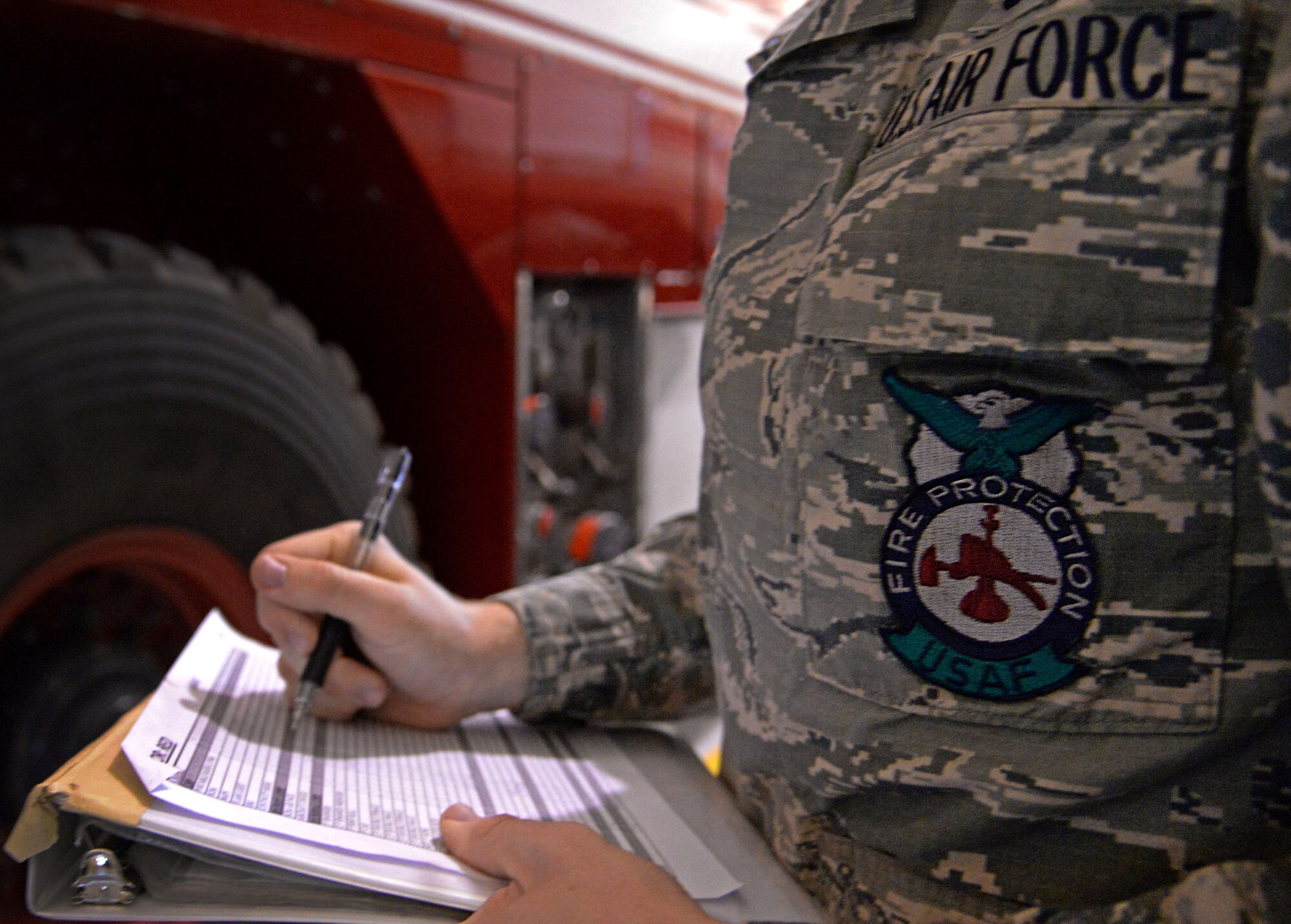 U.S. Air Force Airman 1st Class Tyler Foster, 27th Special Operations Civil Engineer Squadron firefighter, annotates morning inspections on a checklist April 8, 2015 at Cannon Air Force Base, N.M. Cannon’s fire protection crew conducts daily function checks of all operable equipment following morning roll call. (U.S. Air Force photo/Staff Sgt. Alex Mercer) 
