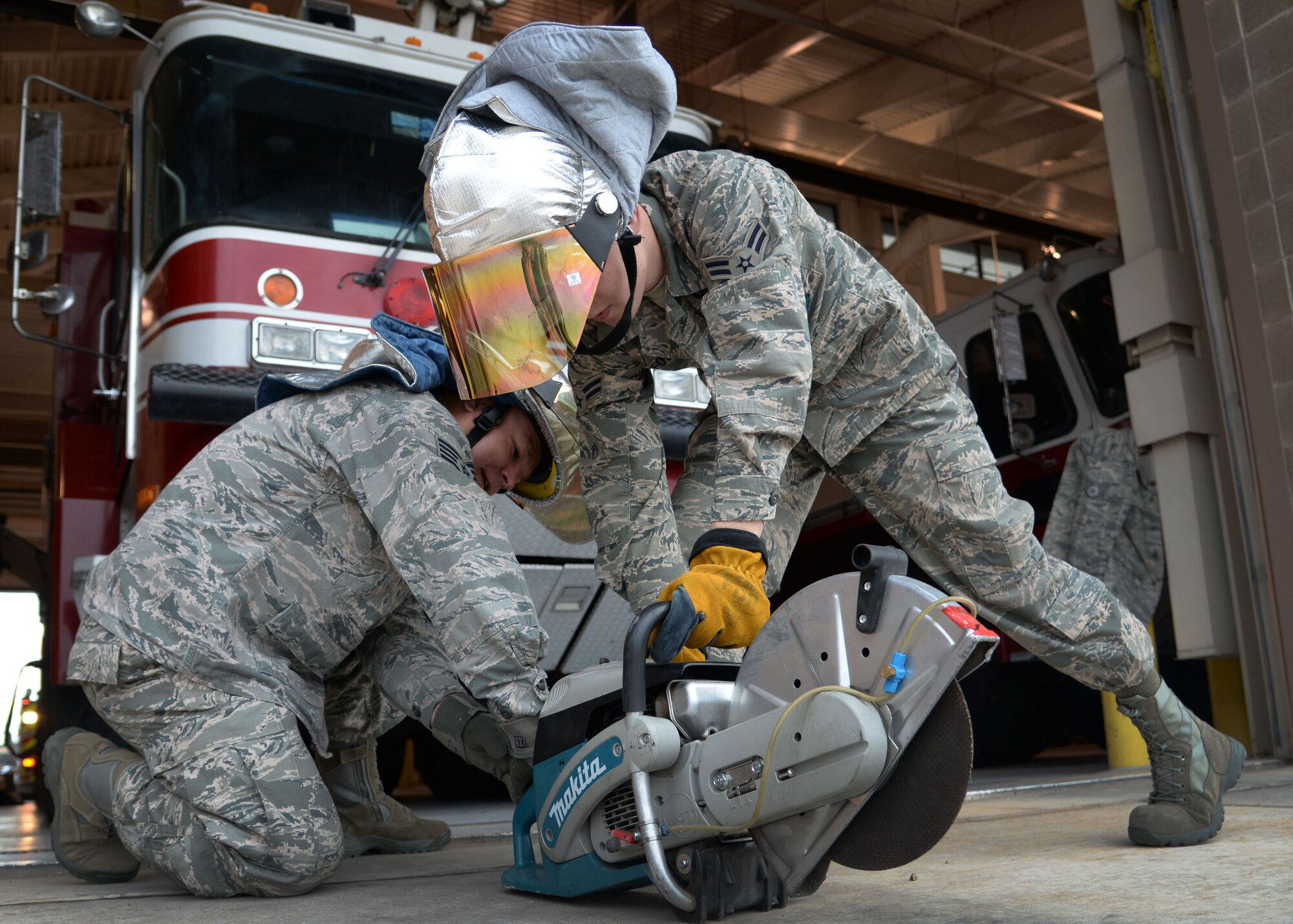 U.S. Air Force Staff Sgt. Joseph Peterson and Airman 1st Class Tyler Foster, 27th Special Operations Civil Engineer Squadron firefighters, ops check a high-power saw April 8, 2015 at Cannon Air Force Base, N.M. The K-12 is used to cut through aircraft in the event of emergency aircrew extraction. (U.S. Air Force photo/Staff Sgt. Alex Mercer) 
