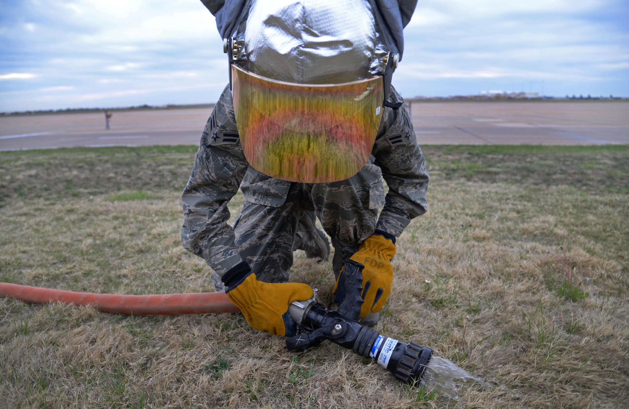 U.S. Air Force Airman 1st Class Tyler Foster, 27th Special Operations Civil Engineer Squadron firefighter, detaches the main nozzle from a hose after ops checks April 8, 2015 at Cannon Air Force Base, N.M. Cannon’s fire protection crew must inspect and tests all essential equipment following morning roll calls. (U.S. Air Force photo/Staff Sgt. Alex Mercer) 
