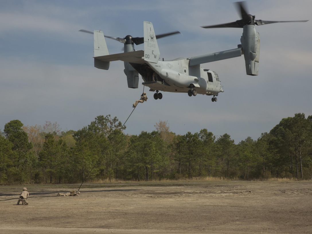 Marines with Lima Company, 3rd Battalion, 8th Marine Regiment, fast-rope from a MV-22B Osprey during a fast-rope exercise aboard Camp Lejeune, N.C., April 8, 2015. The first two Marines out of the aircraft are responsible for anchoring the rope against the rotor winds from the Osprey to assist the others sliding down the rope. (U.S. Marine Corps photo by Lance Cpl. Olivia McDonald/Released)