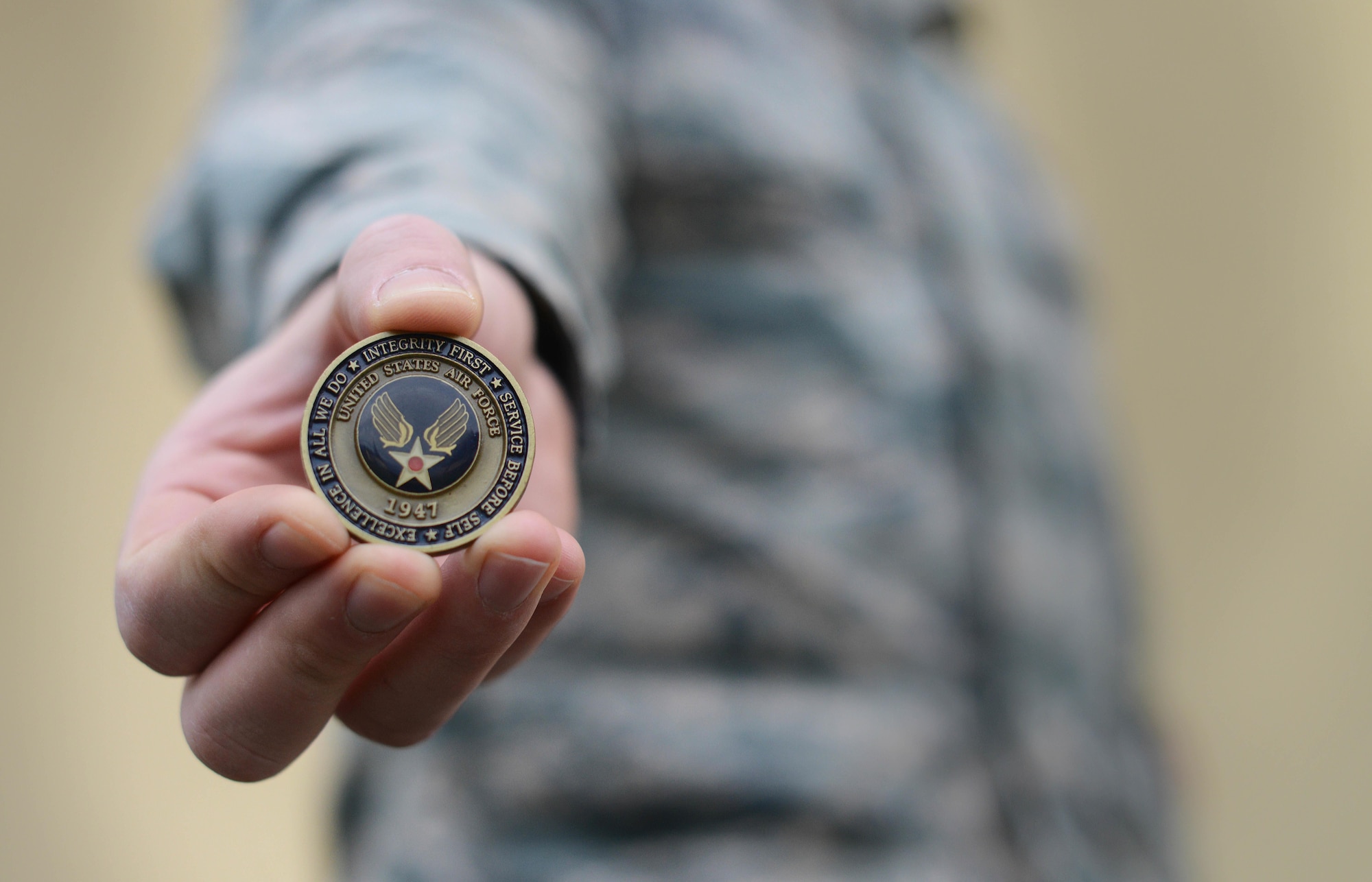 The Airman’s coin signifies the beginning of an enlisted member’s career upon graduating basic military training. The original version of the Airman’s coin featured an eagle clawing its way out of the coin with the words “Aerospace Power” under it. The most recent coin replaced the eagle with the new Air Force symbol. (U.S. Air Force photo/Airman 1st Class Deana Heitzman)