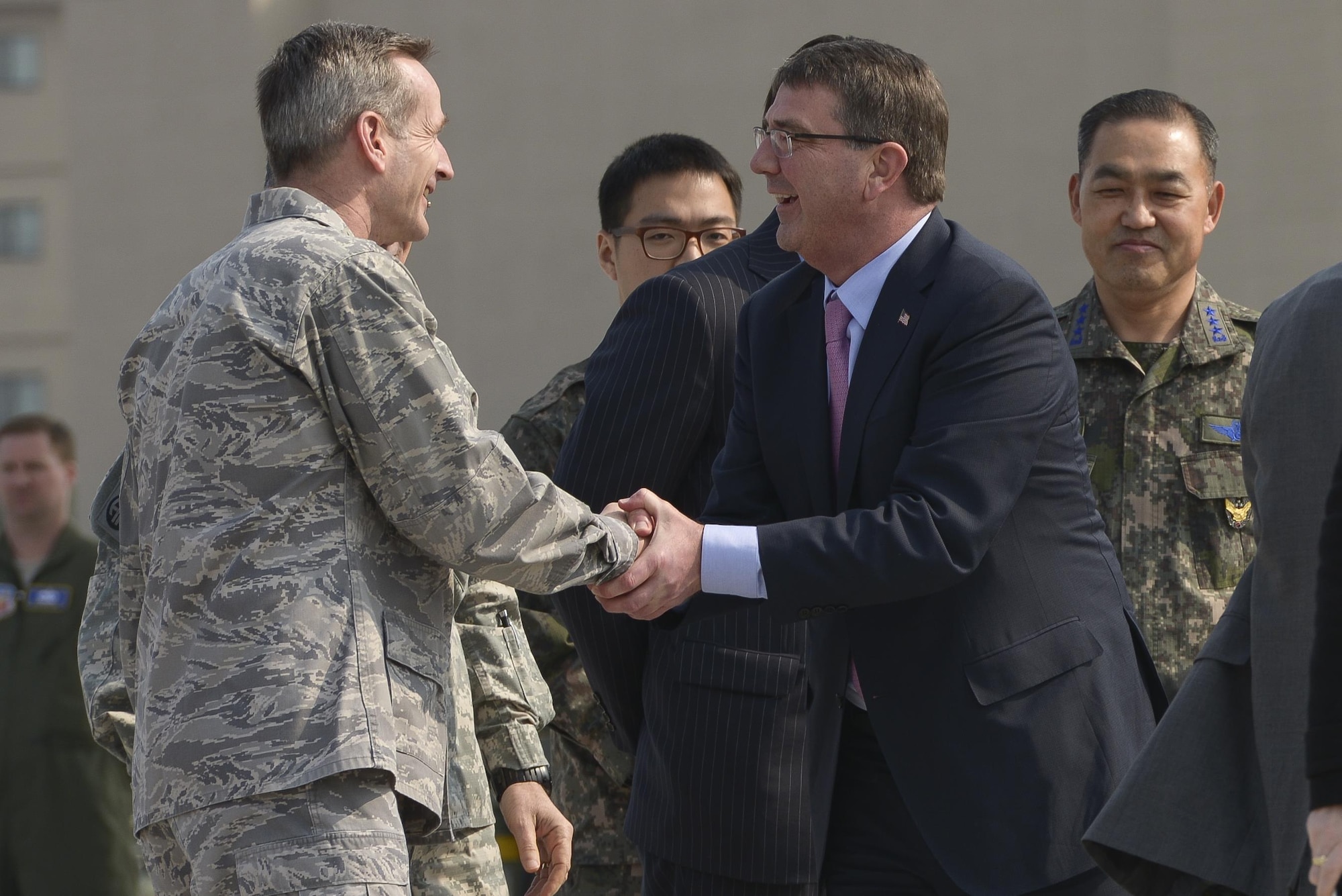 Secretary of Defense Ash Carter is greeted by Lt. Gen. Terrence O'Shaugnessy April 9, 2015, at Osan Air Base, South Korea. Carter was greeted by multiple Air Force, Army, and South Korean leaders when he arrived at the Osan AB. (U.S. Air Force photo/Staff Sgt. Jake Barreiro)