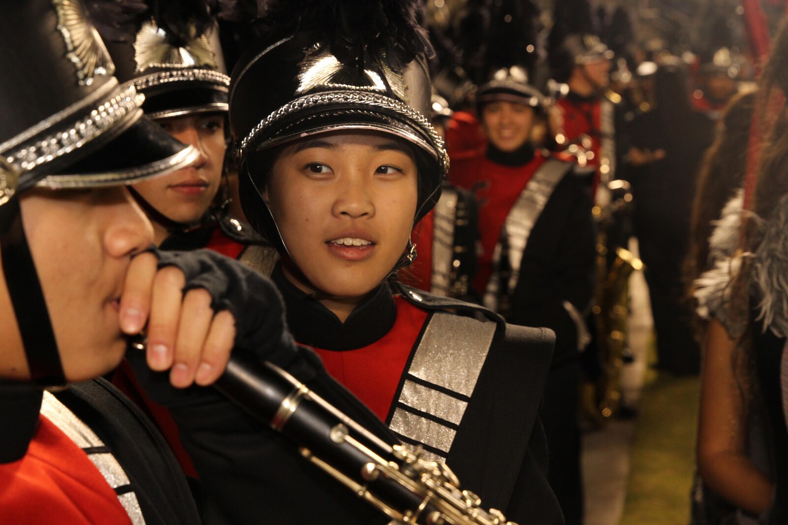 Melissa Chan, Clarinet Section Leader, Colony High School Marching Band, speaks with fellow musician before winning the Battle of the Bands at the 2015 Semper Fidelis All-American Bowl. The bowl honors players who demonstrate the Marine Corps' commitment to developing quality citizens and reinforces core values of honor, courage and commitment on and off the field.