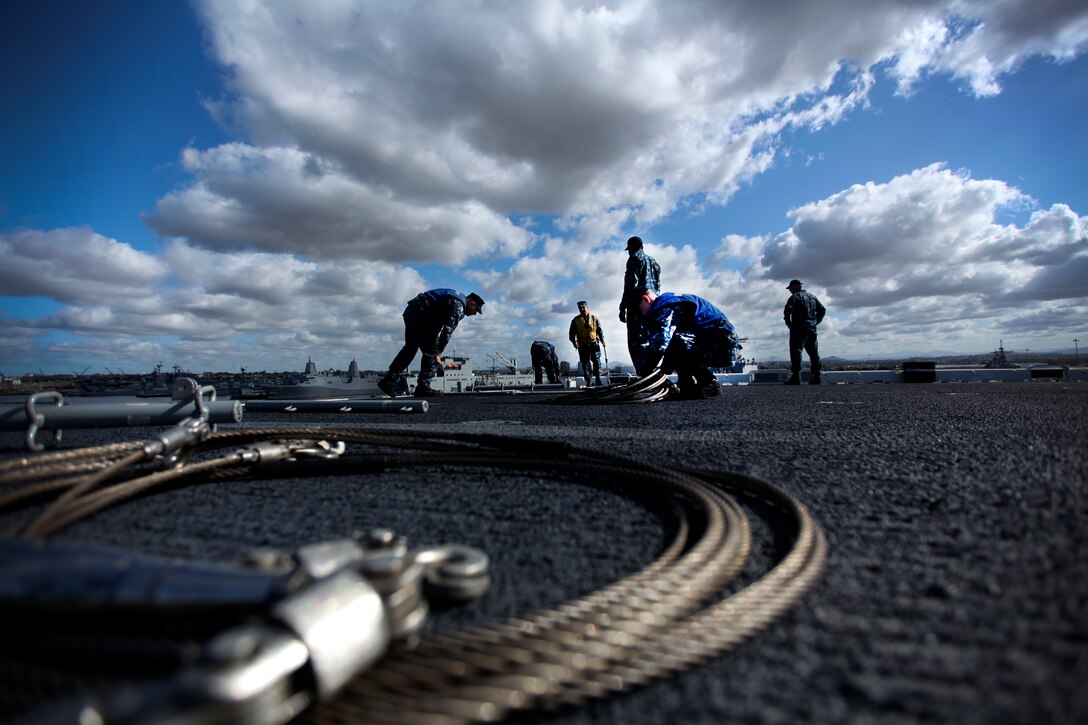 U.S. Sailors clear the railings as the USS Essex (LHD 2) prepares to leave port during Certification Exercise (CERTEX) at Naval Base San Diego April 8, 2015. During CERTEX, the 15th Marine Expeditionary Unit will test everything they have been training for to ensure they are ready for deployment. (U.S. Marine Corps photo by Cpl. Elize McKelvey/Released)