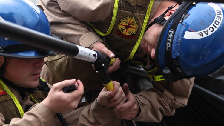 Corpsmen with Chemical Biological Incident Response Force set up a medical tent for casualties during Exercise Silent Ghost in Washington, April 7, 2015.  Corpsmen provided immediate medical attention until victims could get to a hospital. (U.S. Marine Corps Photo by Pfc. David Staten/Released)