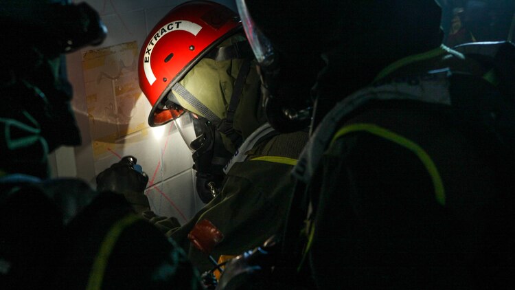 A Marine with Chemical Biological Incident Response Force marks the outside of a door at St. Elizabeth’s East Hospital during Exercise Silent Ghost in Washington, April 7, 2015. Marines mark the doors to let other Marines know they have already worked there so they can moved to other critical points in building. (U.S. Marine Corps Photo by Pfc. David Staten/Released)