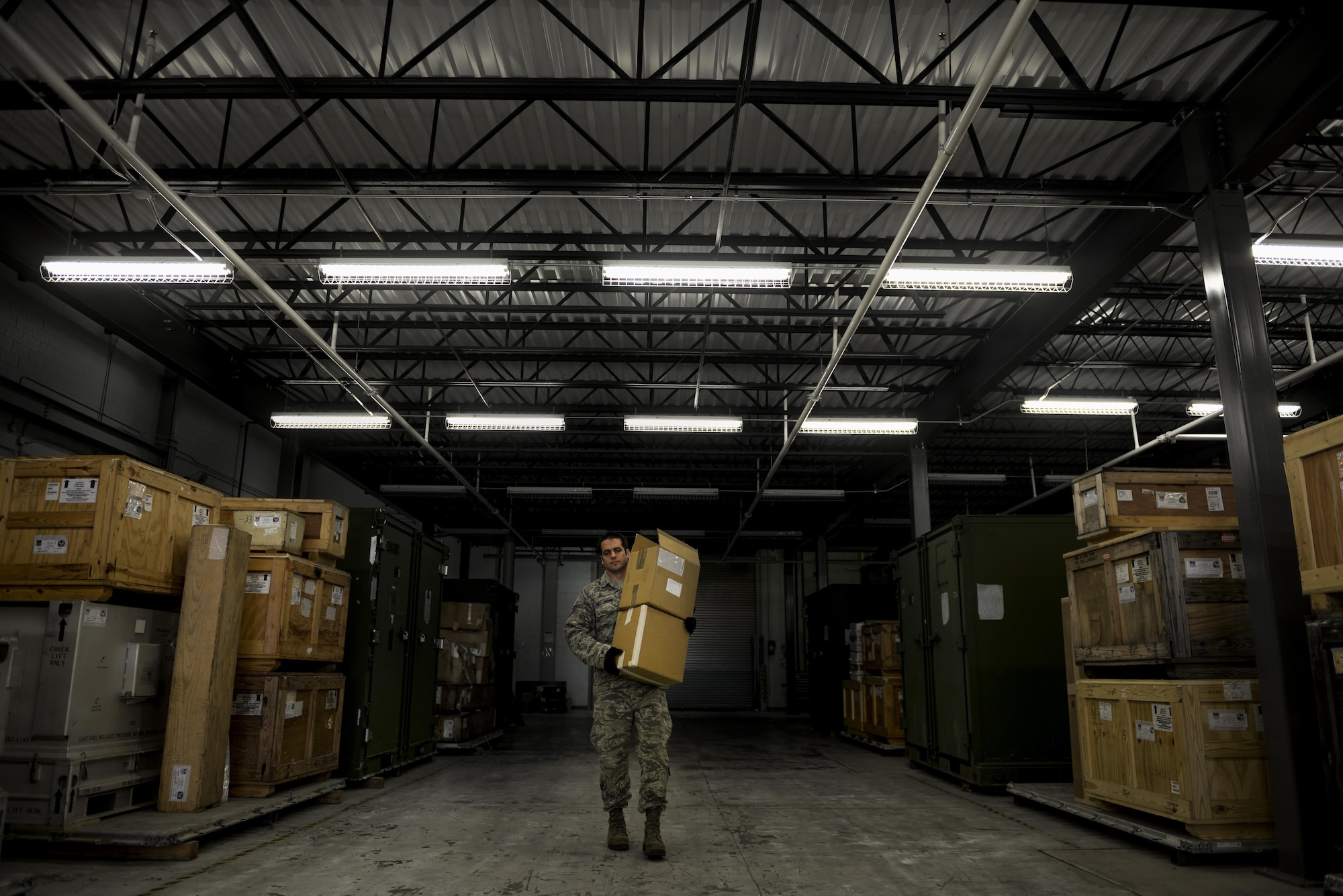 Staff Sgt. Christopher Hollowood, 1st Special Operations Logistics Readiness Squadron CV-22 Osprey parts store supervisor, carries boxes at a warehouse on Hurlburt Field, Fla., April 7, 2015. The Osprey parts store provides efficient supply, expert management and service to accomplish accurate and rapid response to the Osprey’s mission supporting global military operations. (U.S. Air Force photo/Senior Airman Christopher Callaway) 