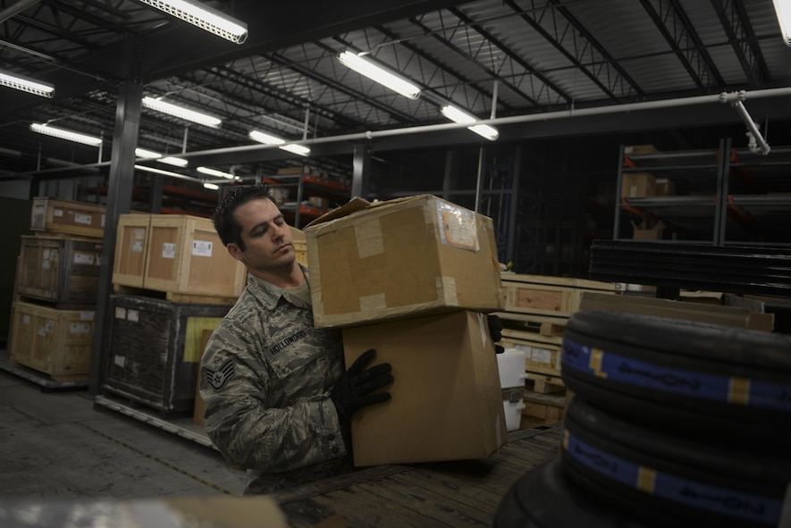 Staff Sgt. Christopher Hollowood, 1st Special Operations Logistics Readiness Squadron CV-22 Osprey parts store supervisor, carries boxes at a warehouse on Hurlburt Field, Fla., April 7, 2015. The Osprey parts store provides efficient supply, expert management and service to accomplish accurate and rapid response to the Osprey’s mission supporting global military operations. (U.S. Air Force photo/Senior Airman Christopher Callaway) 