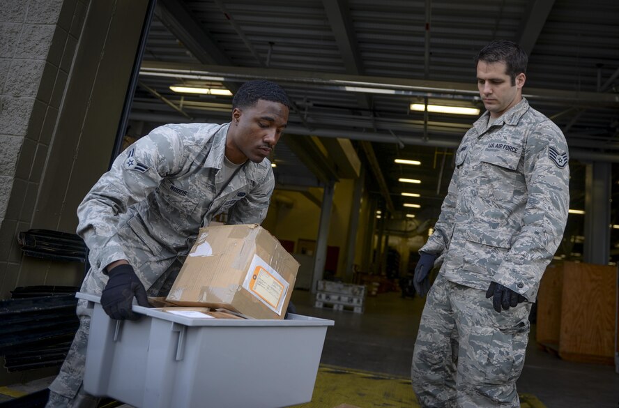 Airman 1st Class Jaquam Woods, 1st Special Operations Logistics Readiness Squadron CV-22 Osprey parts store journeyman and Staff Sgt. Christopher Hollowood, 1st SOLRS CV-22 Osprey parts store supervisor, deliver parts to the main warehouse at Hurlburt Field, Fla., April 7, 2015. The Osprey parts store provides efficient supply, expert management and service to accomplish accurate and rapid response to the Osprey’s mission supporting global military operations. (U.S. Air Force photo/Senior Airman Christopher Callaway) 