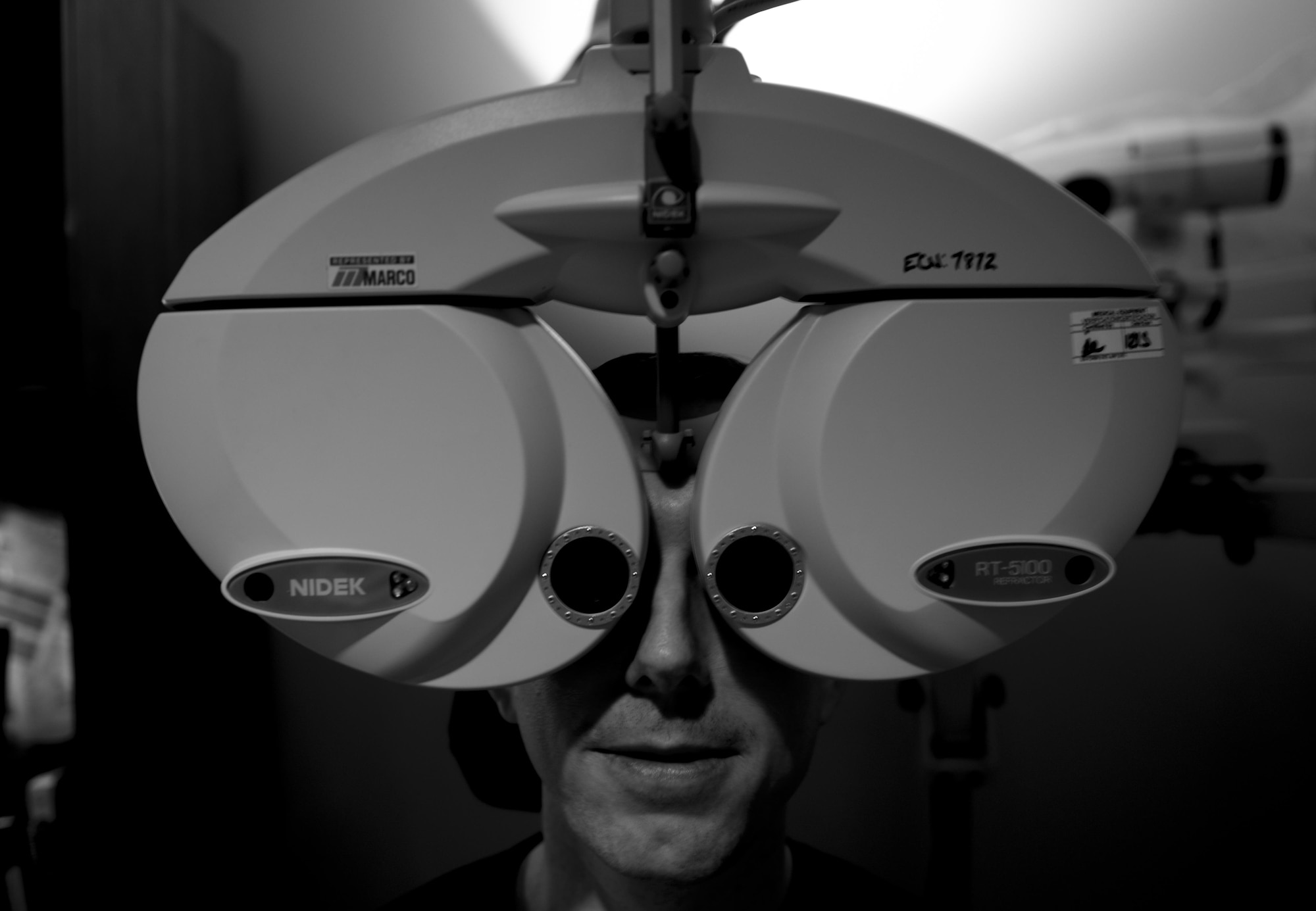 Master Sgt. Andrew Maresh, 1st Special Operations Wing operations security manager, goes through a routine eye exam at the 1st Special Operations Medical Group on Hurlburt Field, Fla., April 8, 2015. Maresh has his eyes checked using a phoropter containing different lenses used for refraction of the eye during sight testing. (U.S. Air Force photo/Senior Airman Christopher Callaway) 