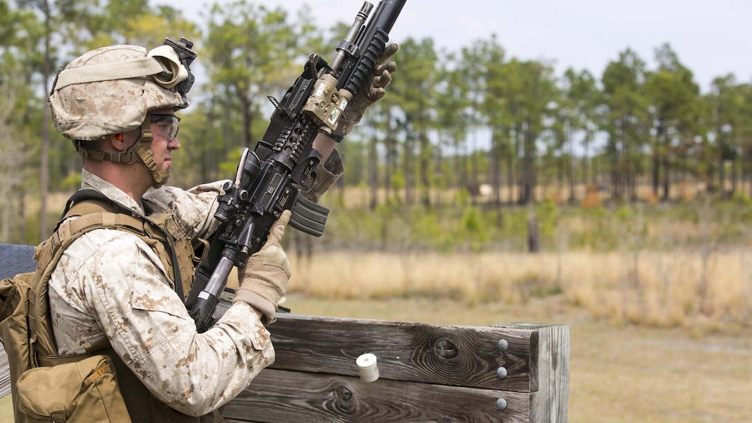 Lance Cpl. Julio Burgos, a rifleman with 2nd Battalion, 2nd Marine Regiment, reloads the M203 rifle-mounted grenade launcher during a live-fire range aboard Camp Lejeune, N.C., April 9, 2015. The M203 is a single-shot grenade launcher capable of accuracy up to 350 meters on an area target and 150 meters on a point target. (U.S. Marine Corps photo by Cpl. Michael Dye/Released) 