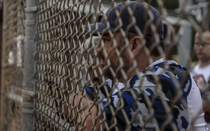 Paul Taylor, 25th Intelligence Squadron pitcher, cheers on his team during a softball game at Hurlburt Field, Fla., April 6, 2015. The game pitted the 25th IS against the 1st Special Operations Security Forces Squadron. (U.S. Air Force photo/Senior Airman Christopher Callaway)