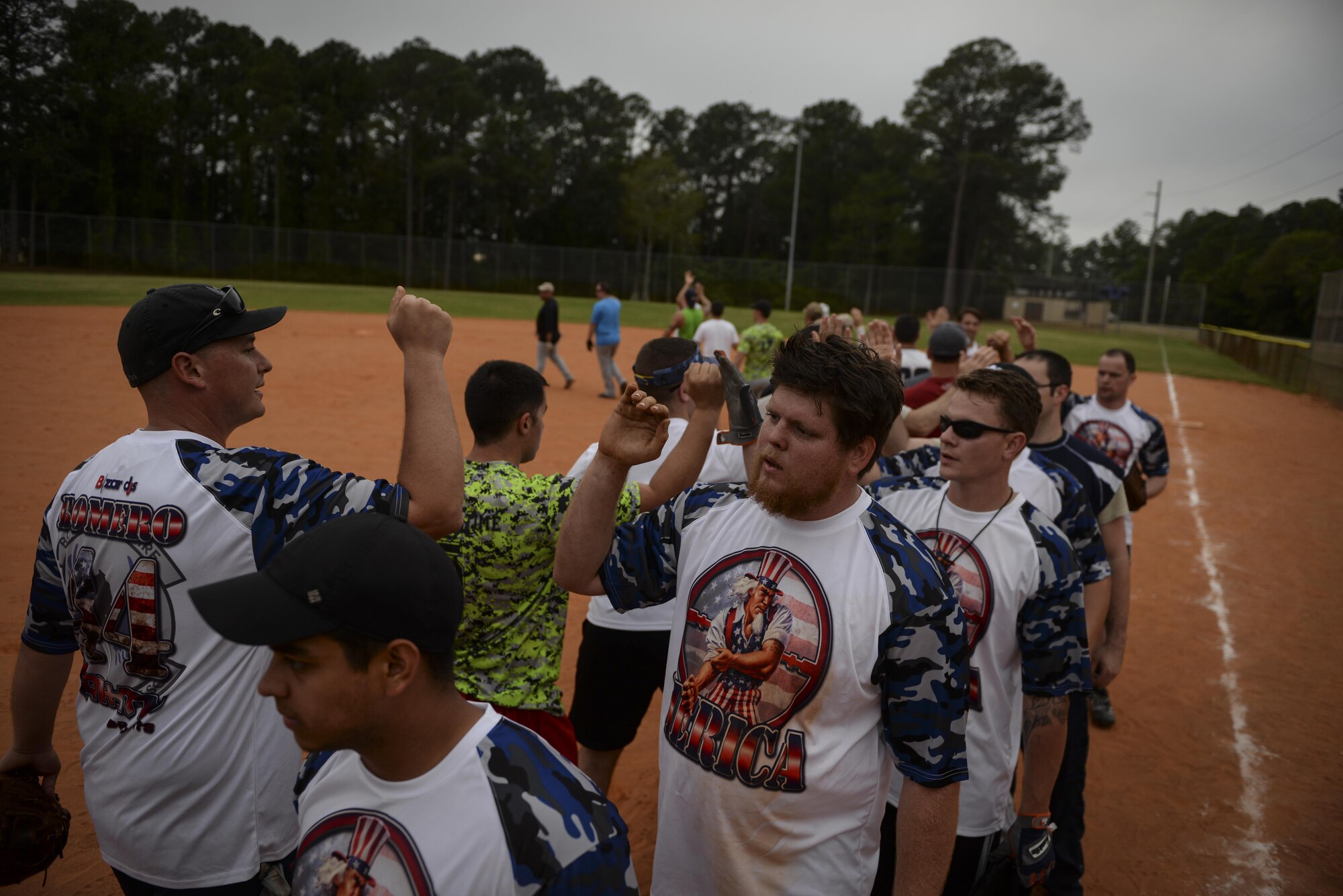 Members from the 25th Intelligence Squadron and 1st Special Operations Security Forces Squadron shake hands at the end of a softball game at Hurlburt Field, Fla., April 6, 2015. The game ended with the 1st SOSFS winning 17 to 2, according to the final score sheet. (U.S. Air Force photo/Senior Airman Christopher Callaway) 