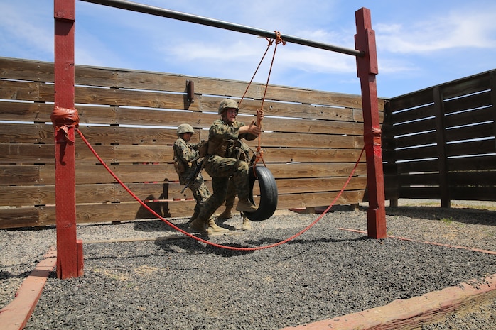 Private First Class William R. Potter, Platoon 2166, Hotel Company, 2nd Recruit Training Battalion, assists his fire team during the 12 Stalls event at Edson Range, Marine Corps Base Camp Pendleton, Calif., March 31. In a simulated mission, the fire team was tasked with supplying a new tire to a platoon with a flat tire. The difficult part of completing the simulated resupply was a minefield between the team and the platoon. Today, all male recruits recruited from recruiting stations west of the Mississippi are trained at MCRD San Diego. The depot is responsible for training over 16,000 recruits annually. Company H is scheduled to graduate from recruit training, April 10.
