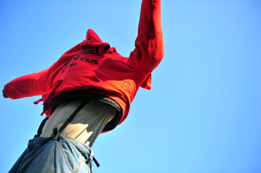 Staff Sgt. Terrell Beasley, 1st Special Operations Security Forces Squadron military working dog handler, dons a protective suit used for bite training, April 8, 2015, at Hurlburt Field, Fla. MWD handlers keep training as realistic as possible so if a situation arises, the handler and dog have the confidence to perform when the mission requires. (U.S. Air Force photo/Airman 1st Class Ryan Conroy)