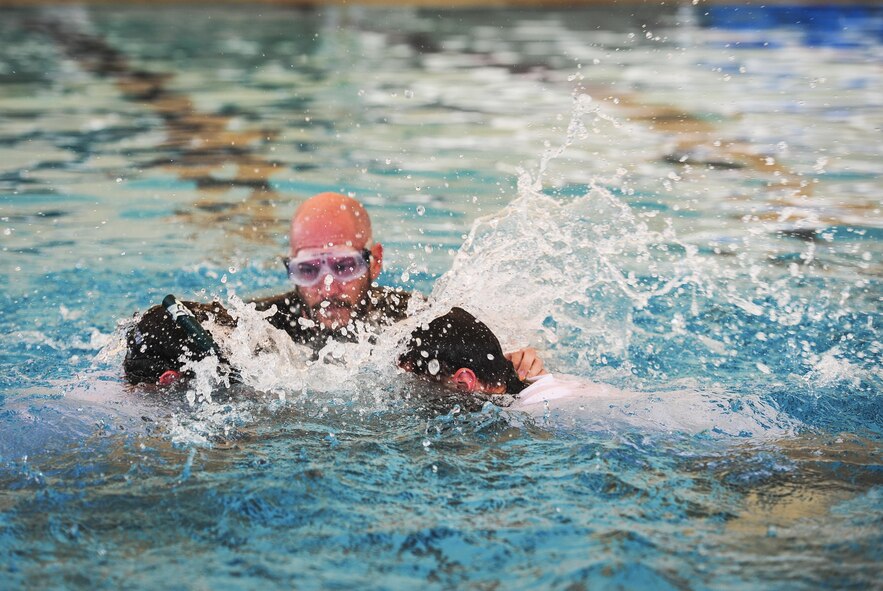 Airmen from the Special Tactics Training Squadron, 24th Special Operations Wing, Hurlburt Field, Fla., participate in buddy breathing, Mar. 9, 2015. The STTS trains special operations forces, including combat controllers and special tactics pararescueman, for rapid global employment to enable airpower success in austere and hostile environments. (U.S. Air Force photo by Senior Airman Meagan Schutter)