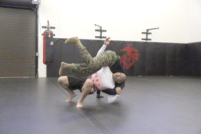 Major Jackson Doan, operations officer, Edson Range, Weapons Field Training Battalion, Marine Corps Base Camp Pendleton, practices a take-down using his expertise in the martial arts. Doan has been named 2014 Marine Corps Athlete of the Year.