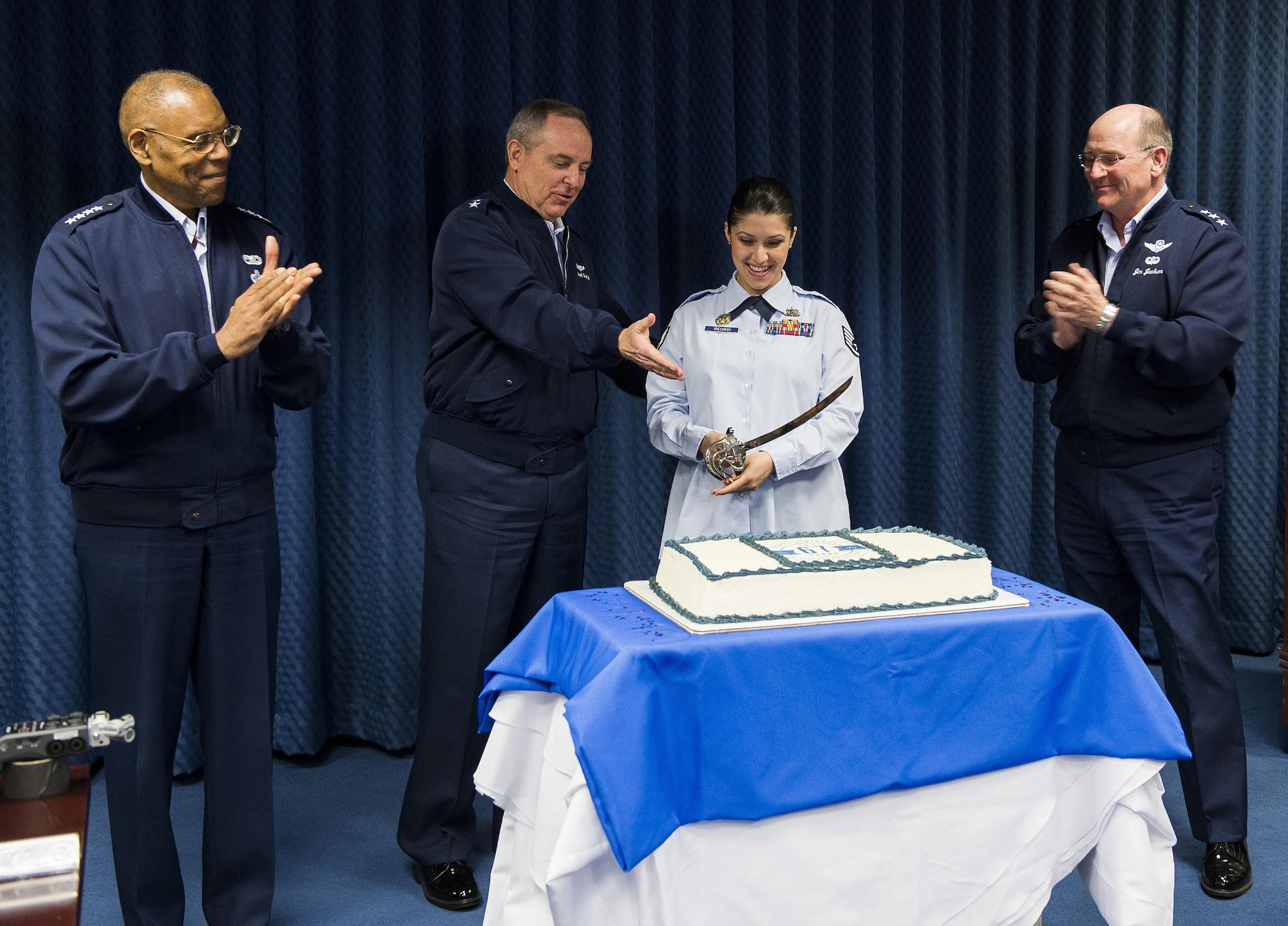 Air Force Chief of Staff Gen. Mark A. Welsh III (second from left) invites the junior most ranking member of Reserve Affairs (RA) staff, Staff Sgt. Ivanka Vrechkov (third from left) to cut a cake celebrating the Air Force Reserves 67th birthday during a ceremony in the Pentagon, April 6, 2015, Washington, D.C. Also on hand for the ceremony were Vice Chief of Staff Gen. Larry Spencer (left) and Chief of the Air Force Reserves Lt. Gen. James Jackson (right).  Vrechkov is the Non-Commissioned Officer in Charge of Policy Integration for RA. The reserves were established on April 14, 1948 by President Harry S. Truman, seven months after the active duty Air Force was established as a separate service. Originally the reserves were a standby force for use in wartime and national emergencies. The Air Force Reserves became a Major Command (MAJCOM) in 1973 and began working side-by-side with their active duty counterparts. The reserves also perform unique missions such as pararescue and weather reconnaissance. (U.S.Air Force photo/Jim Varhegyi)